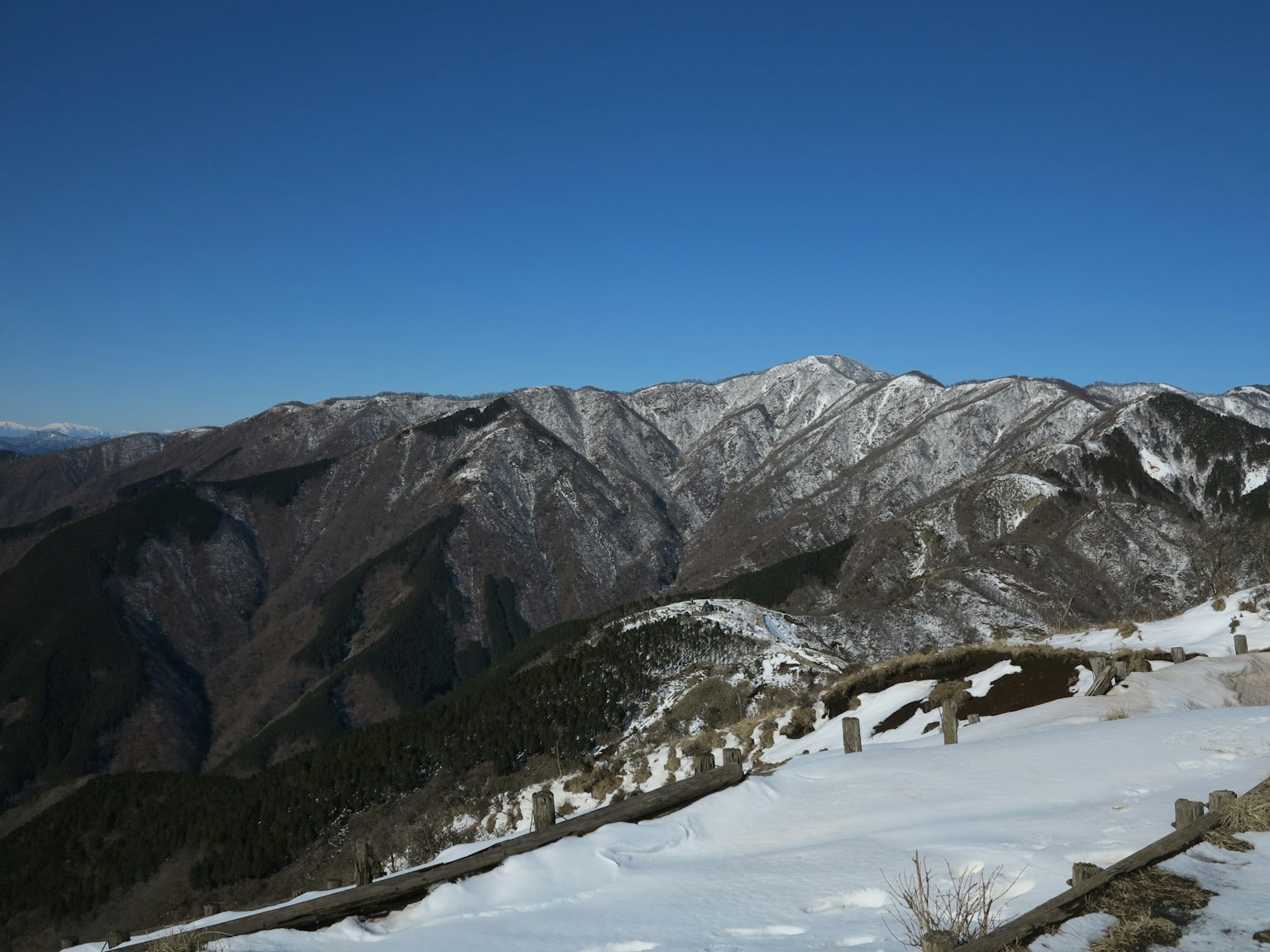 Snow-covered mountains under a clear blue sky