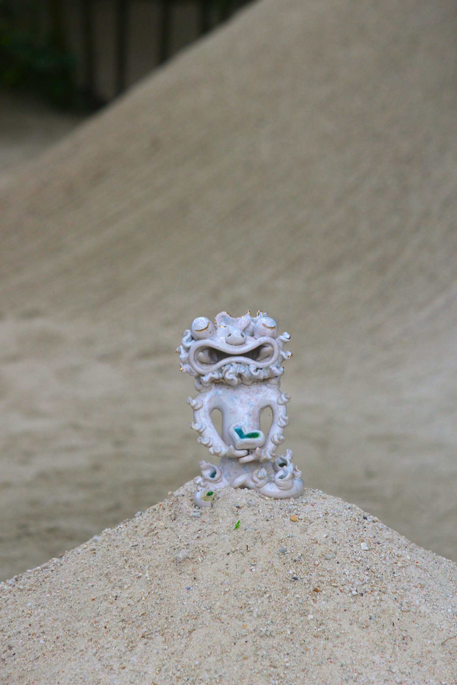 A beautiful white ornament placed on sand showcasing its texture