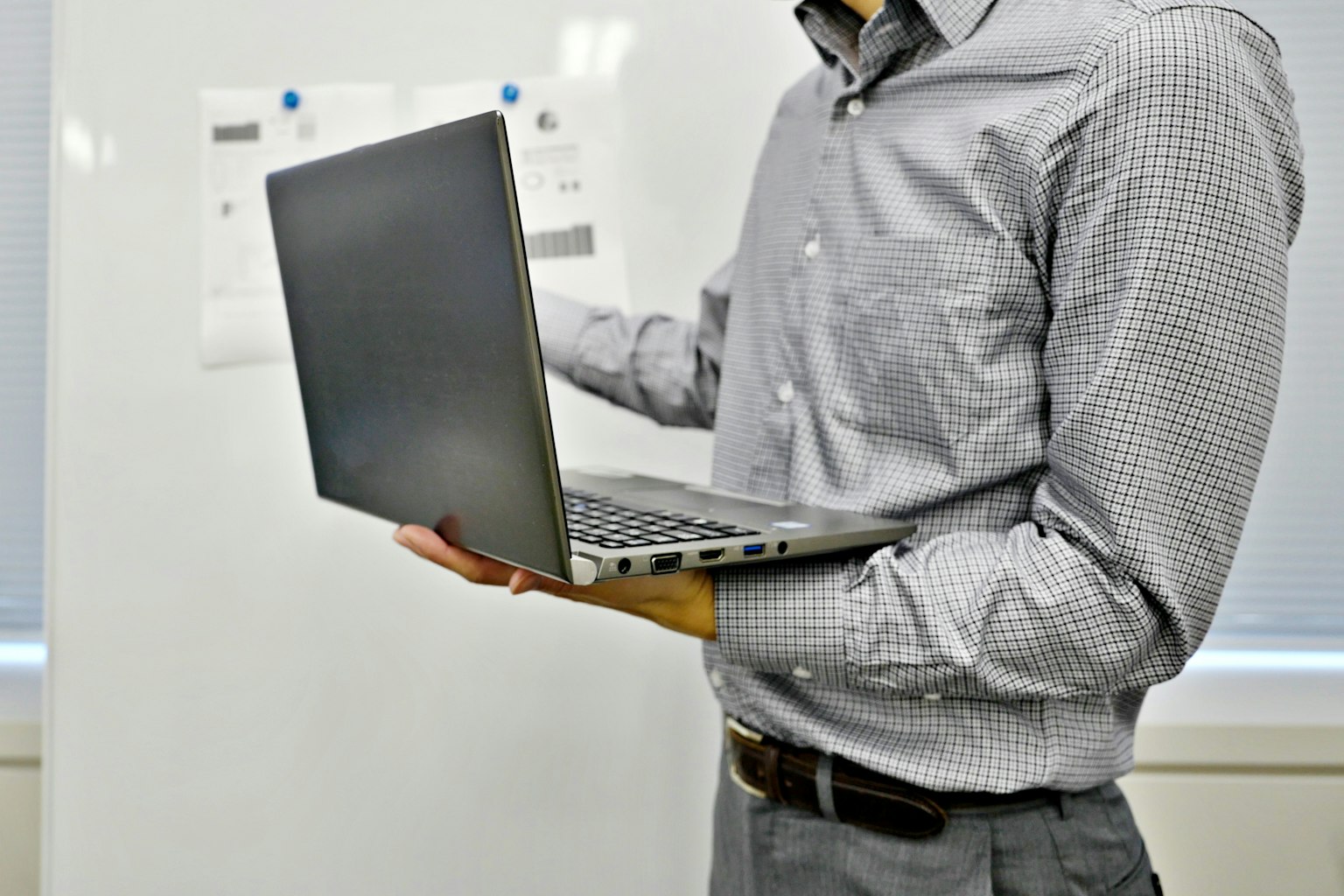 Hombre de negocios sosteniendo una laptop mientras da una presentación