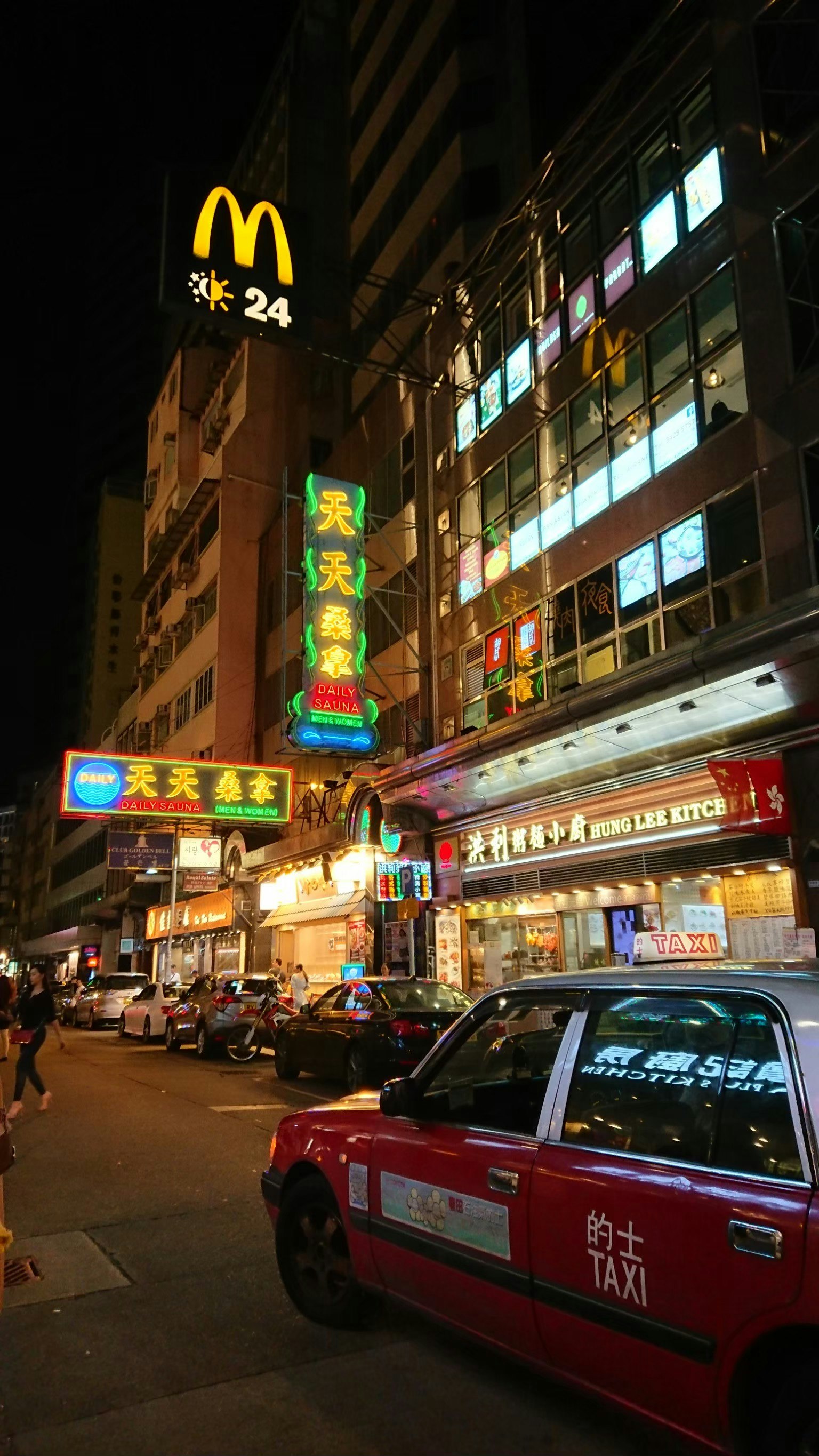Nachtszene mit McDonald's-Schild und Taxi