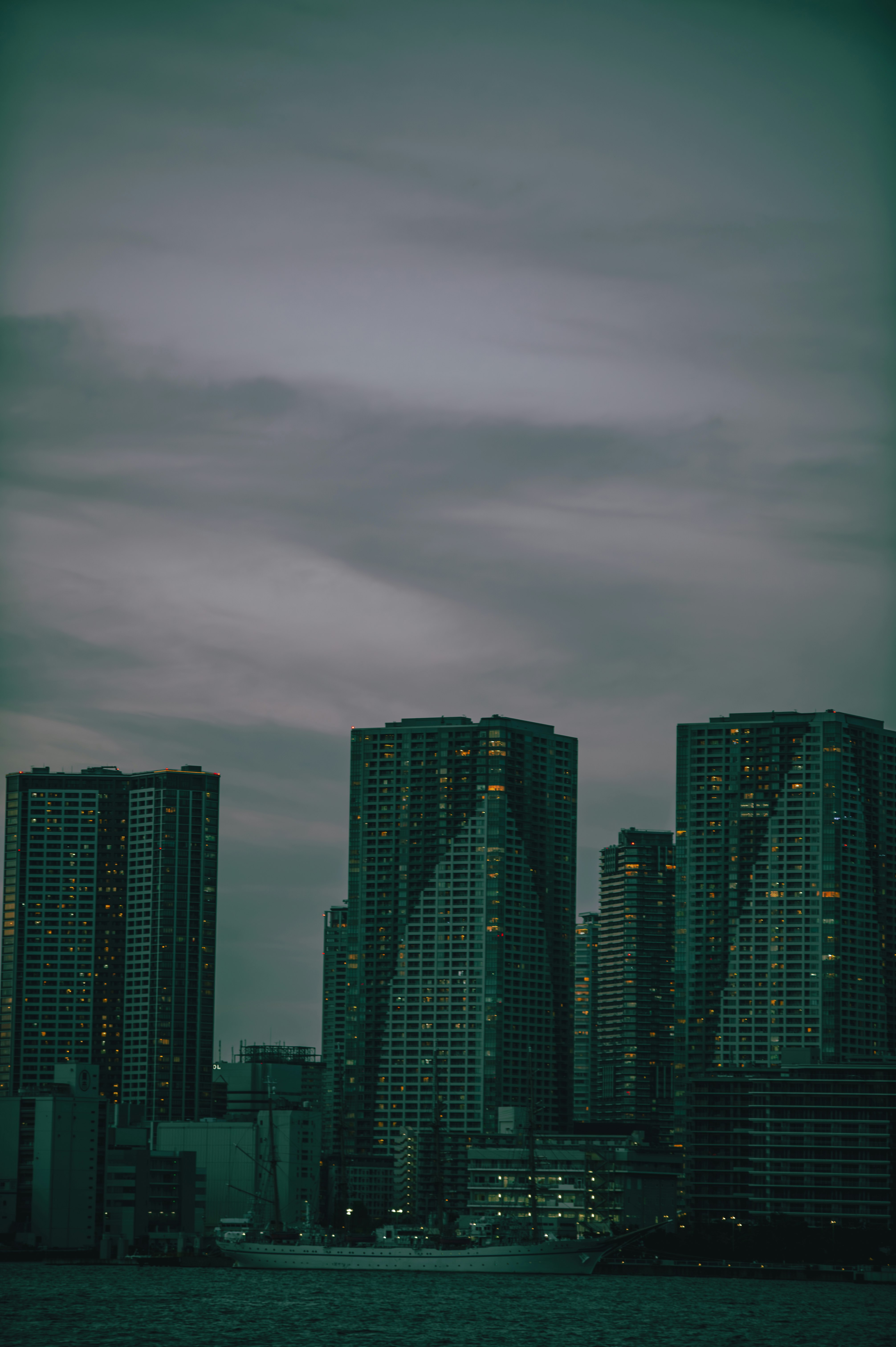 hazy waterfront skyline of tall apartment towers