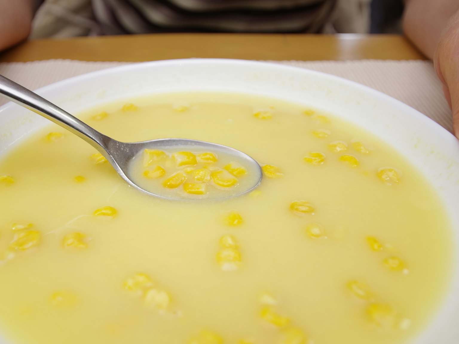 Image of cream corn soup with a spoon