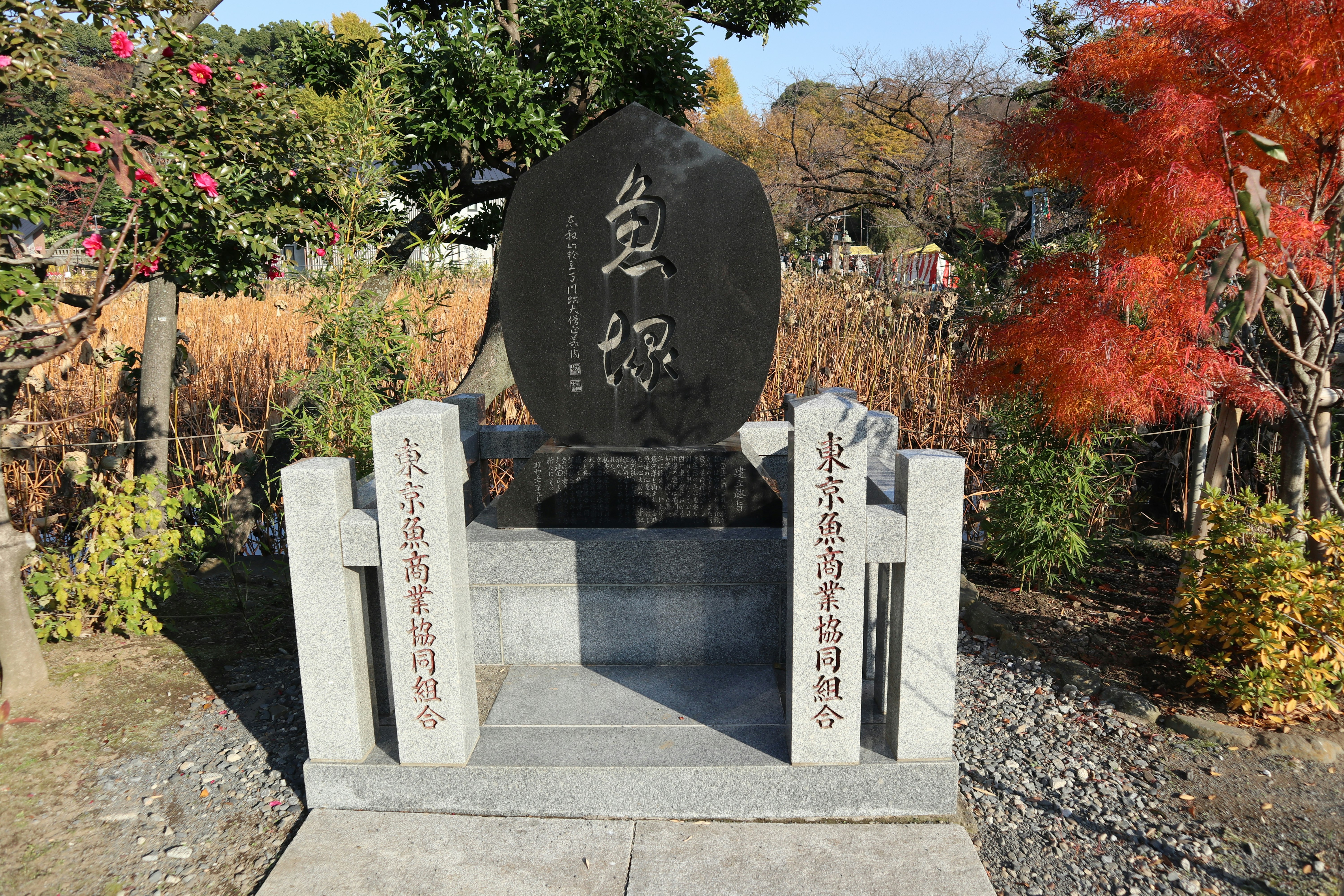 Garden path with stone monuments and autumn foliage