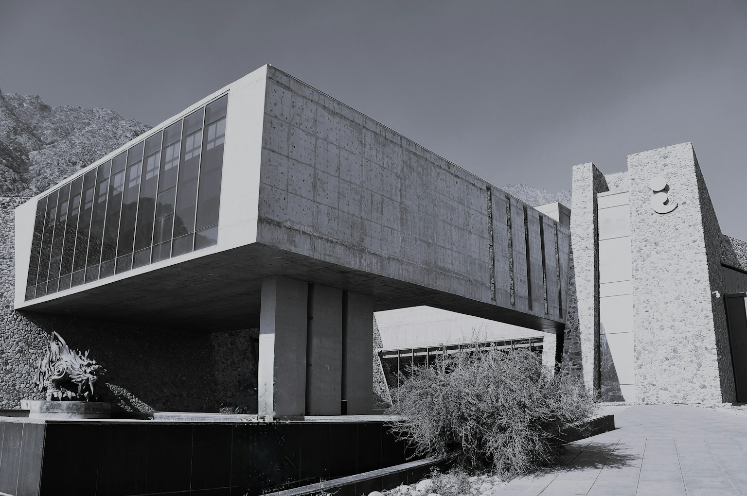 Modern concrete building with large windows and unique architecture