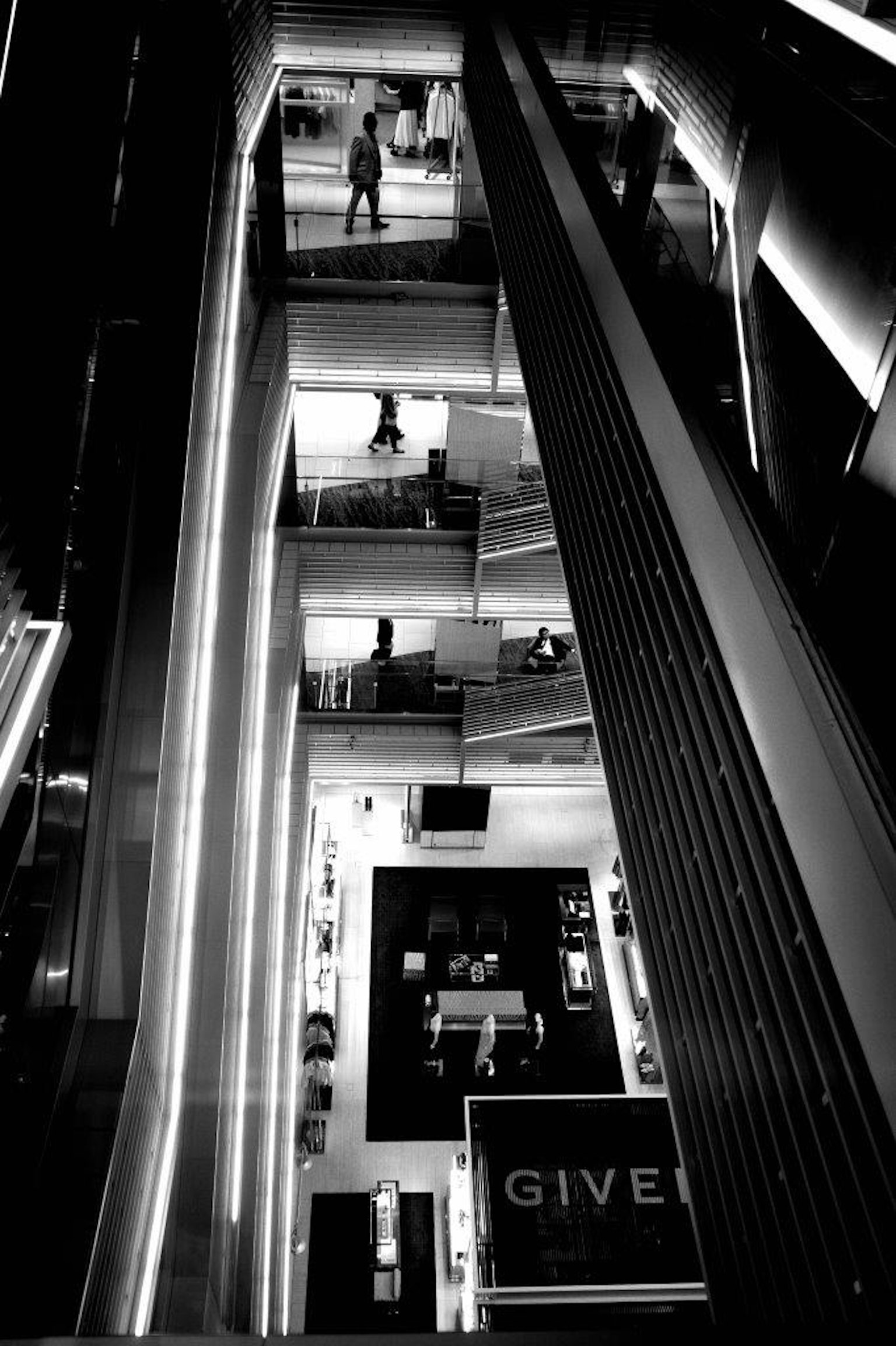 View of multiple floors from inside a modern elevator shaft