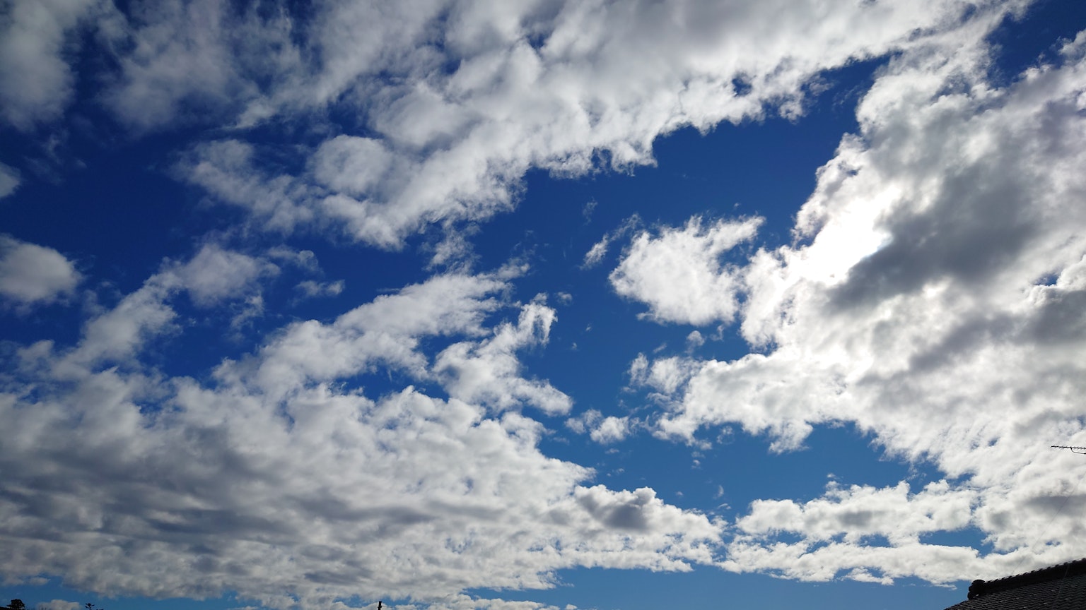 Expansive blue sky with white clouds