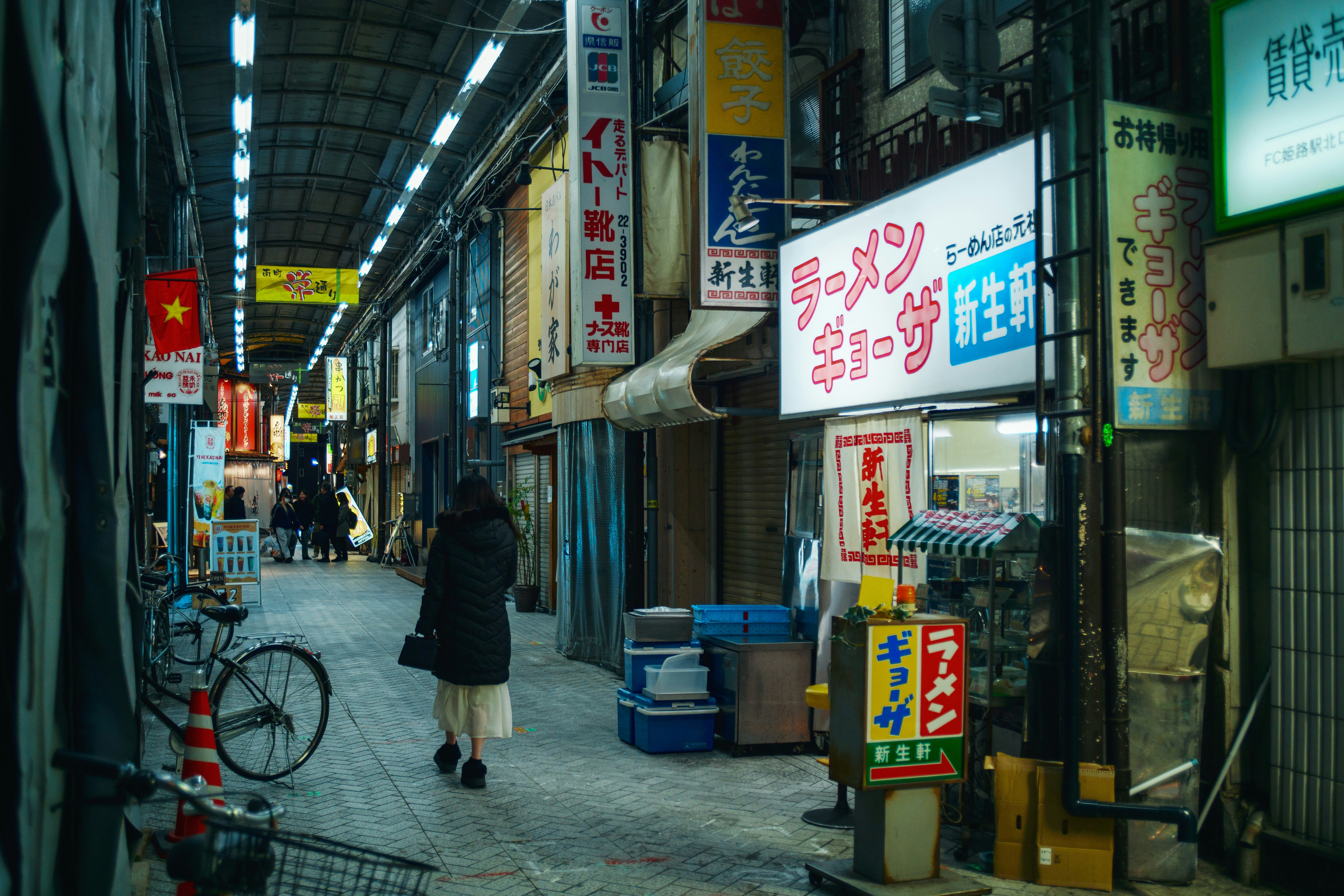 Retro shopping alley storefronts with bicycles along the lane
