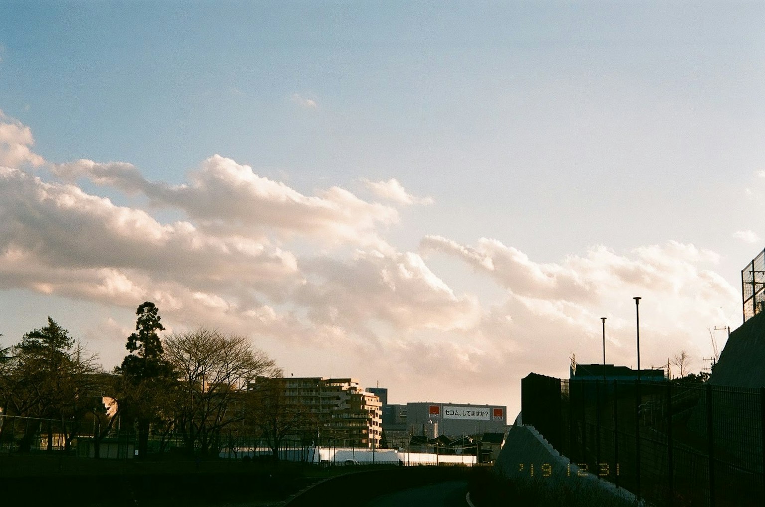 Urban landscape under a blue sky with white clouds