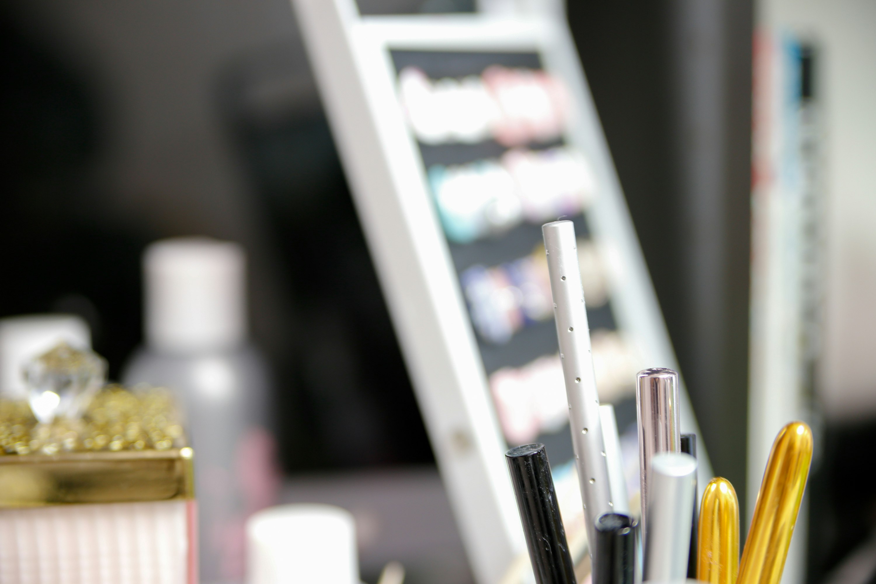 makeup brushes and beauty tools arranged on a vanity