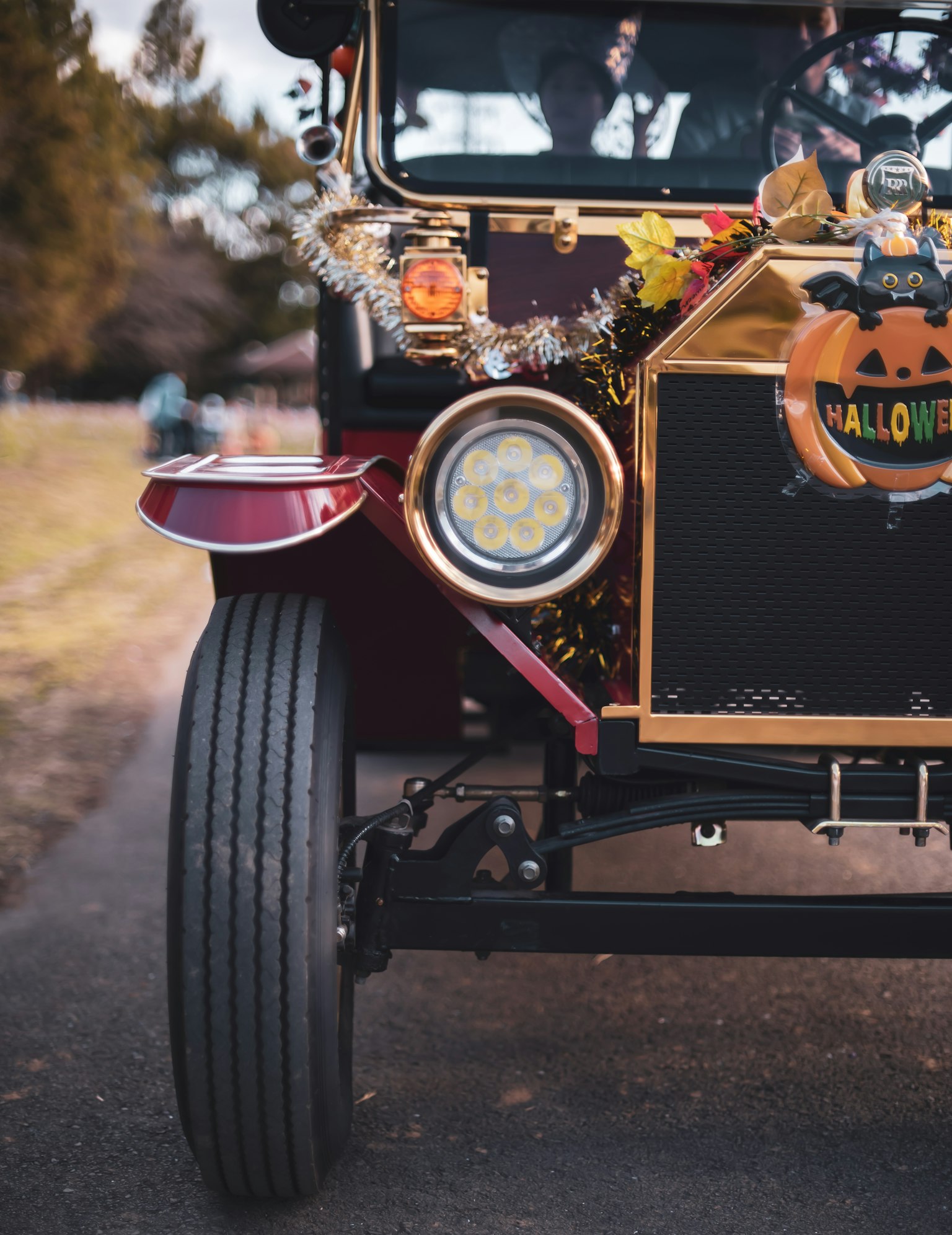 Front view of a vintage car decorated with Halloween elements and vibrant colors