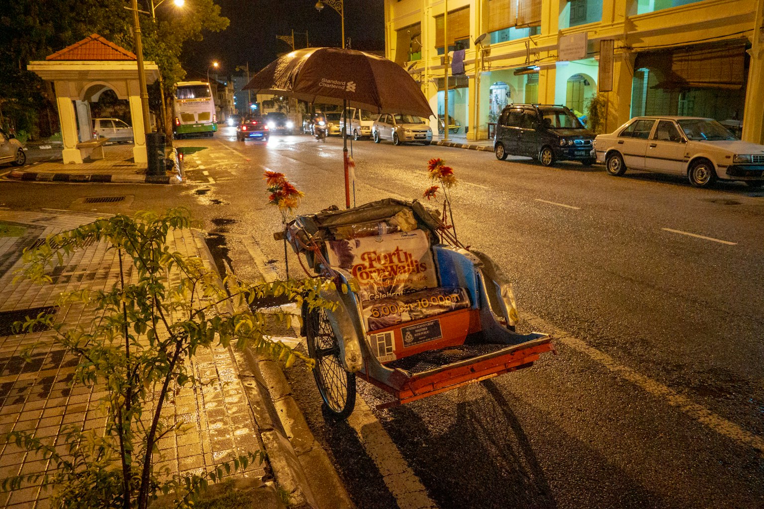 Street cart with umbrella on a nighttime street scene