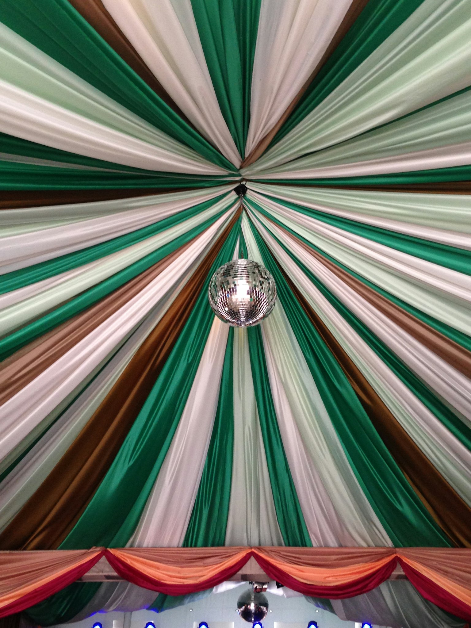 Striped ceiling in green and white with a sparkling disco ball