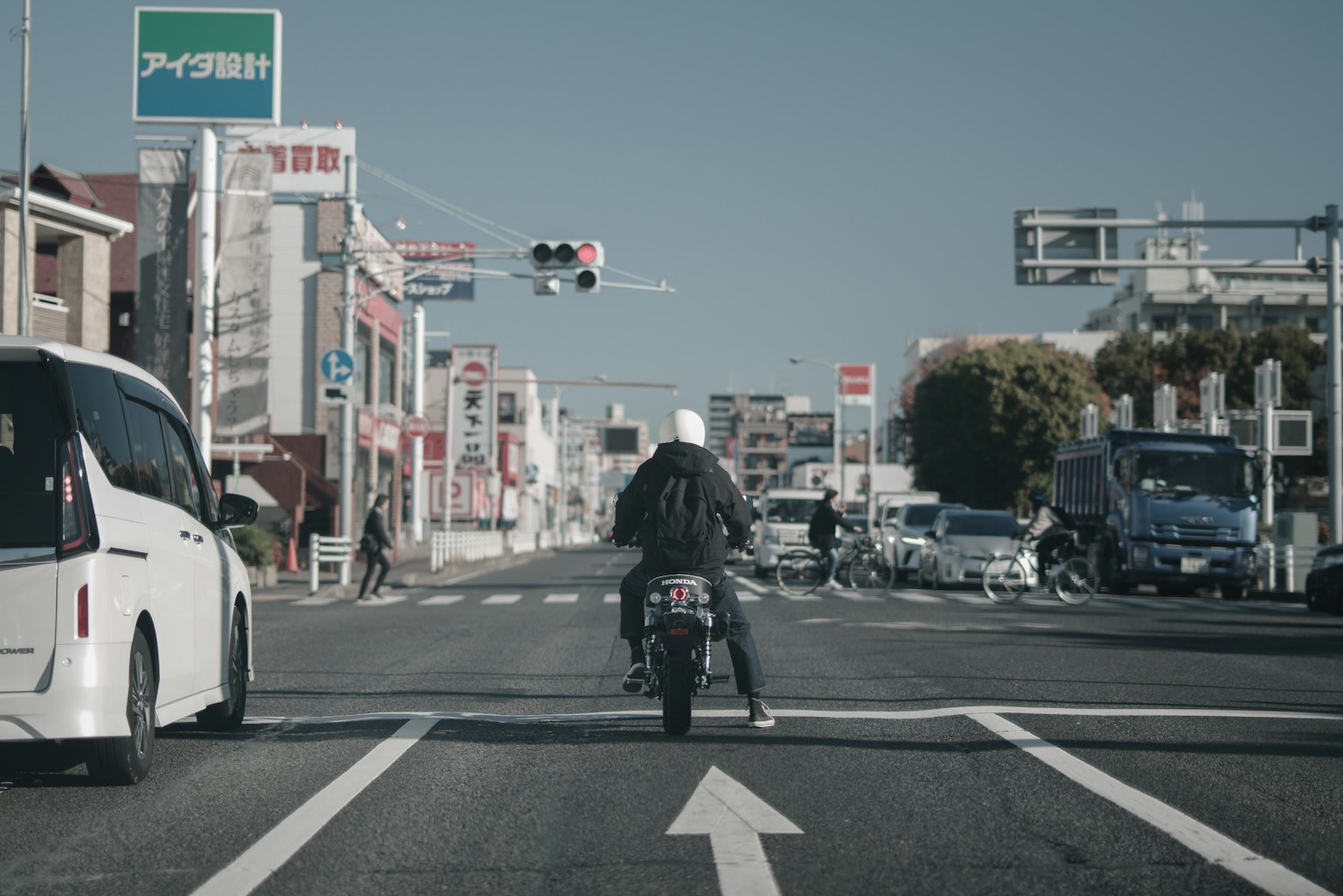 バイクに乗った人物が街の通りを走っている風景