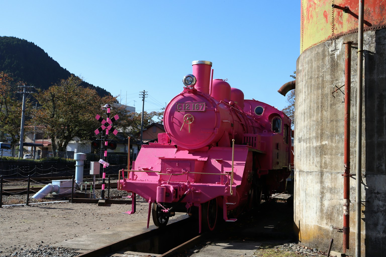 ピンクの蒸気機関車が駅に停まっている風景