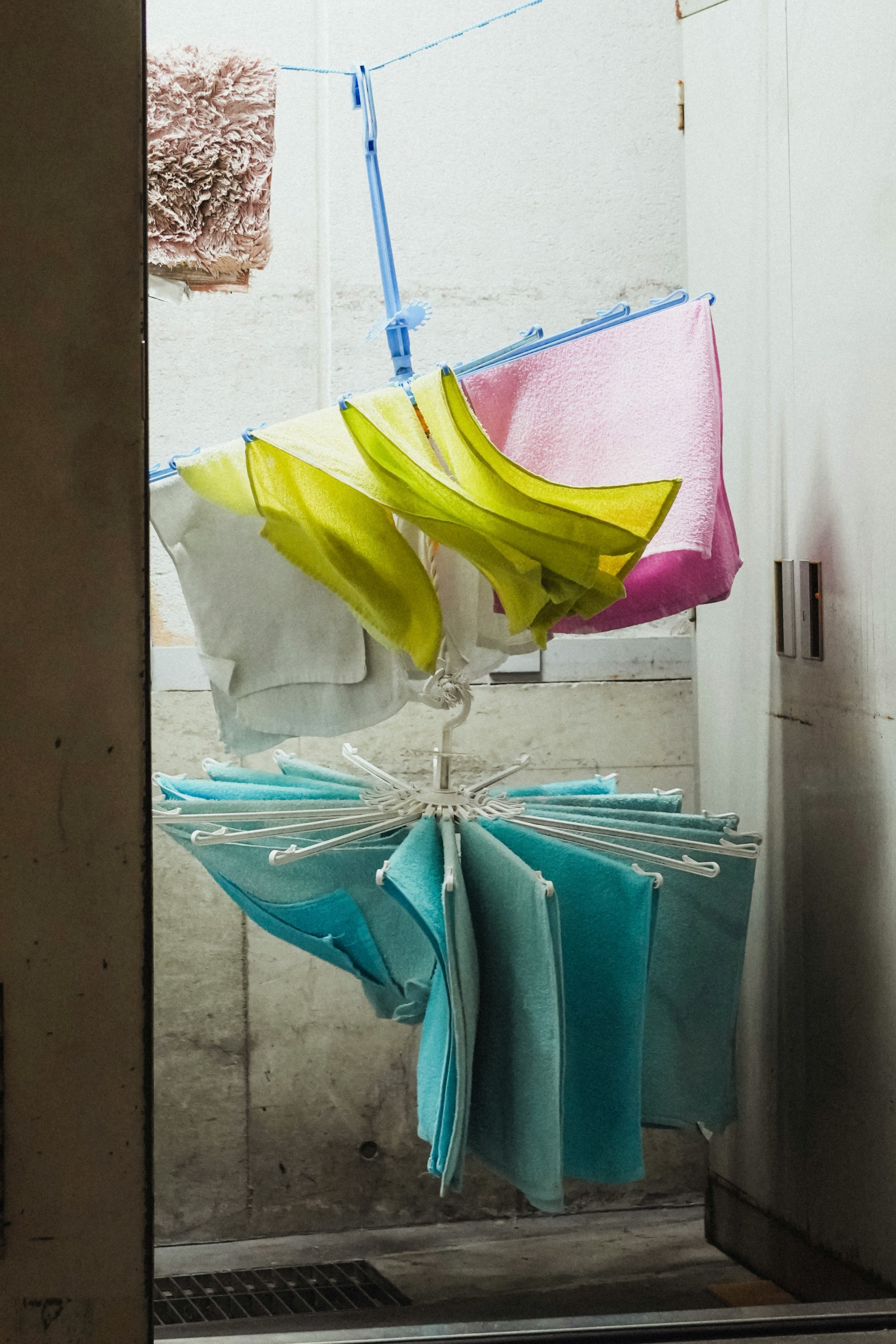 indoor clothes drying rack with colorful laundry