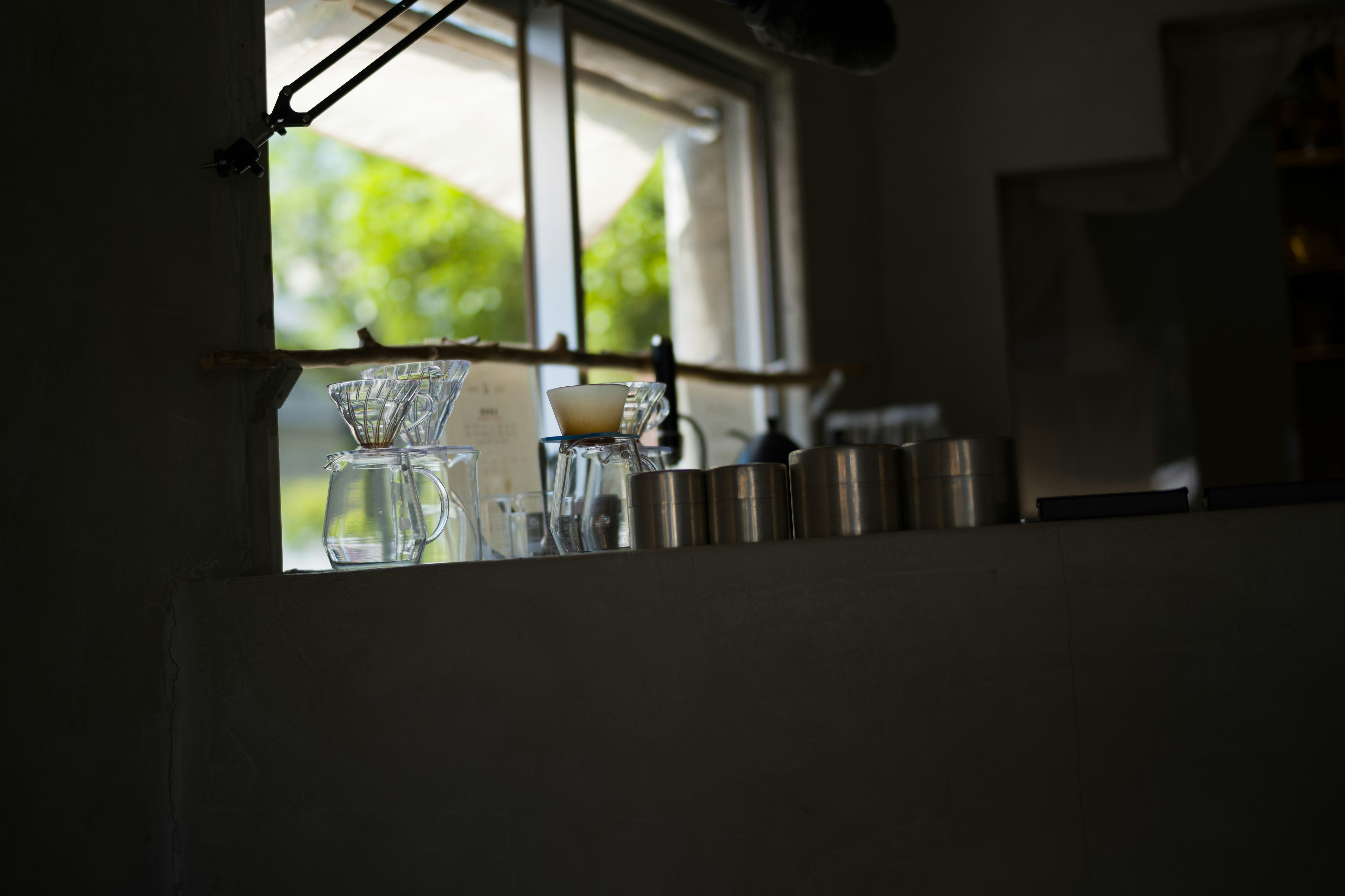 Quiet coffee drip scene seen across a counter