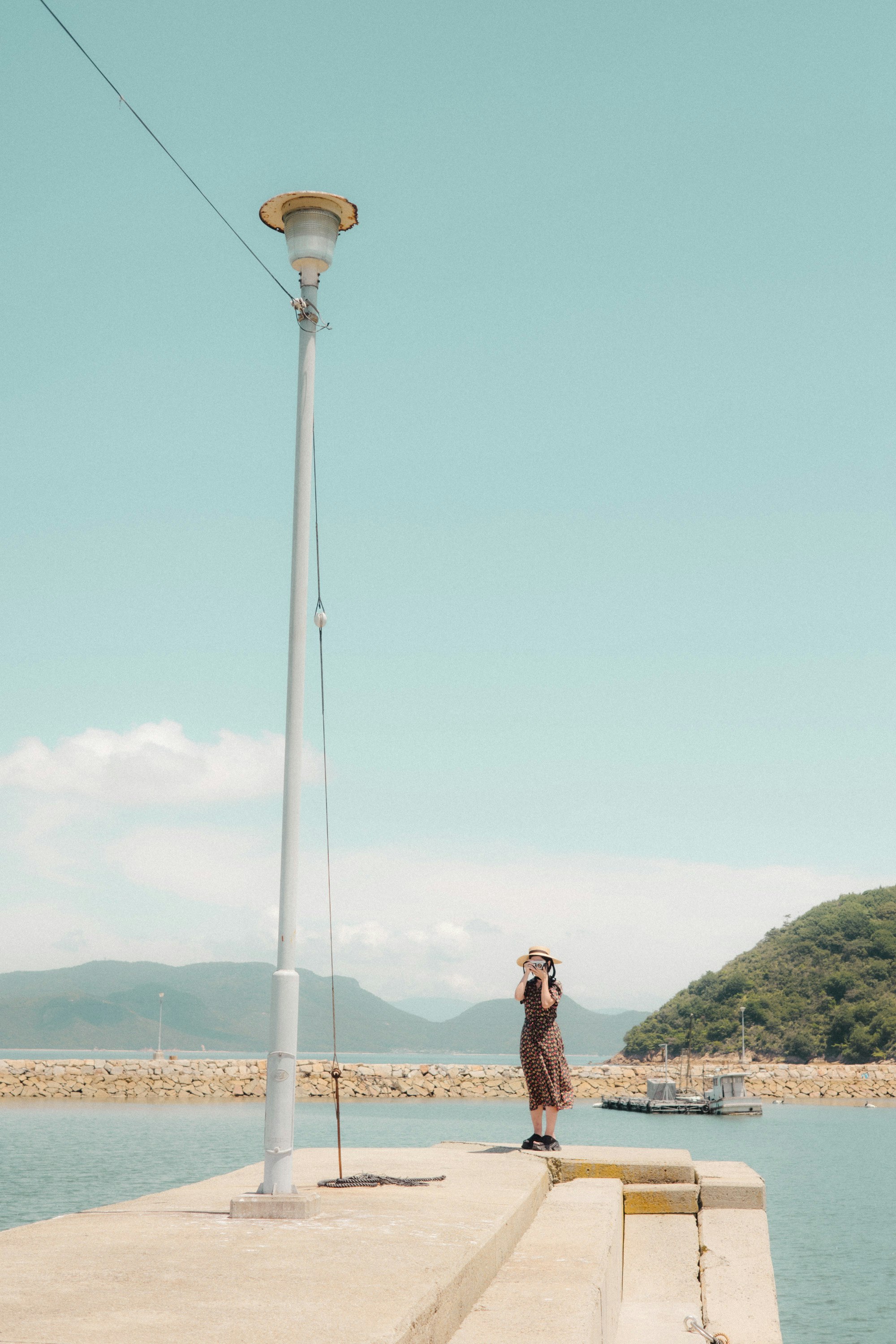 Person photographing by the seaside on Naoshima