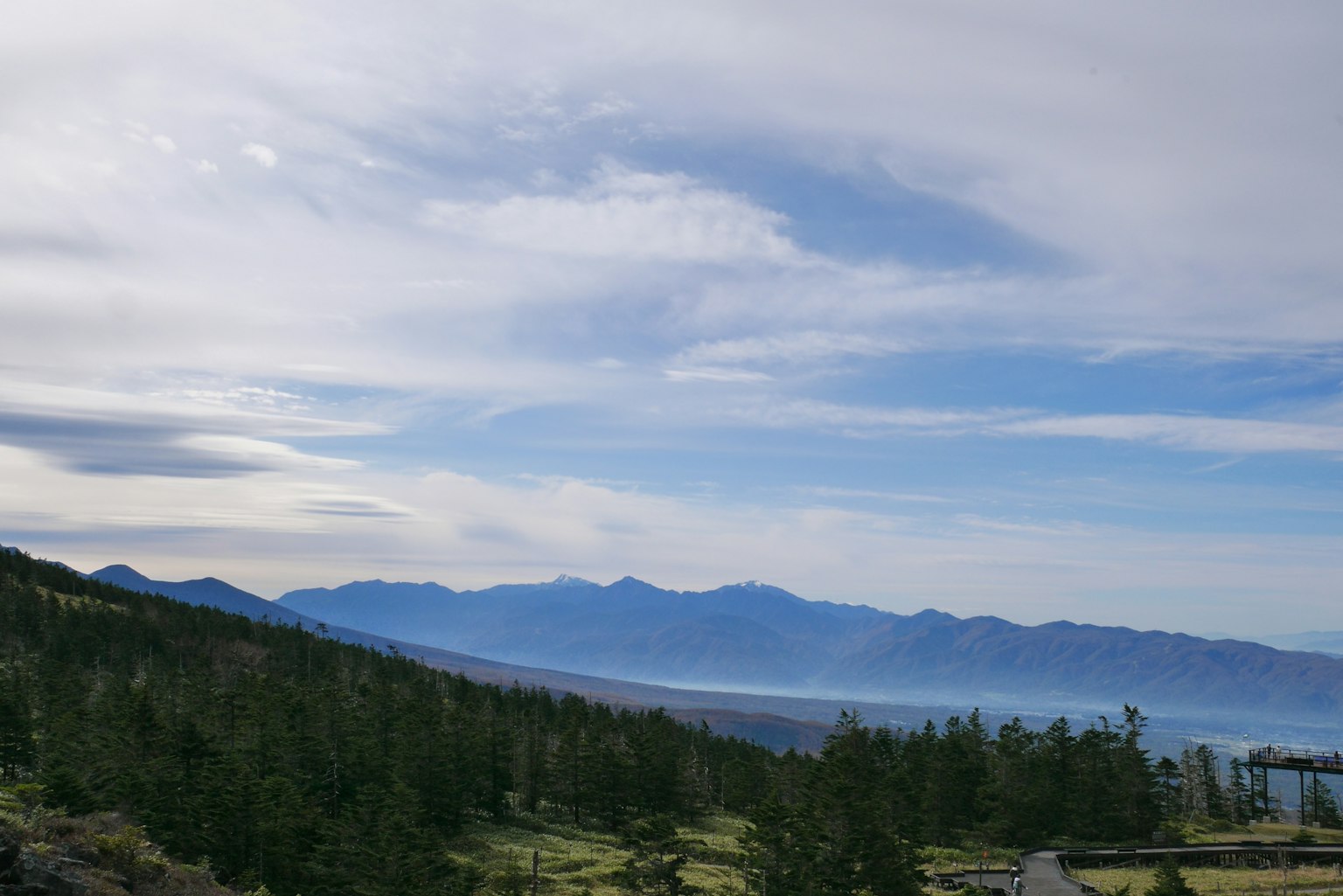 Mountain landscape with blue sky and clouds green trees and vast mountains
