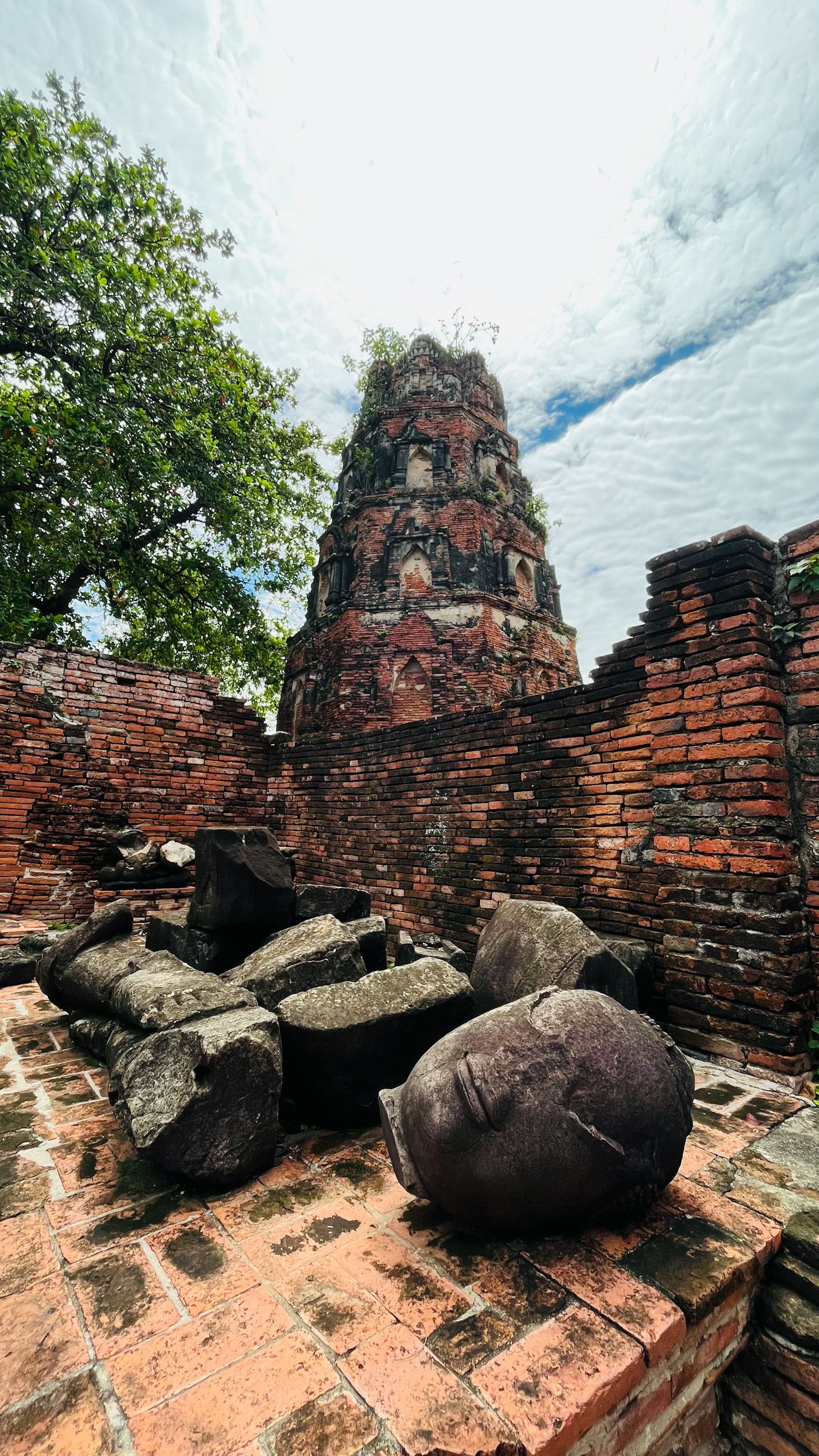 View of ancient ruins with a stone tower and large spherical stones