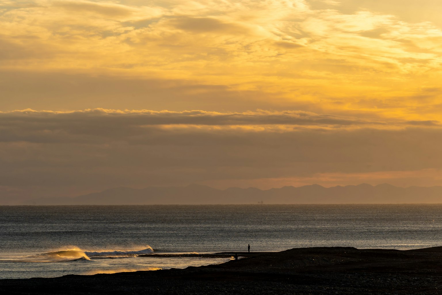 Scenic view of a coastline with sunset and waves