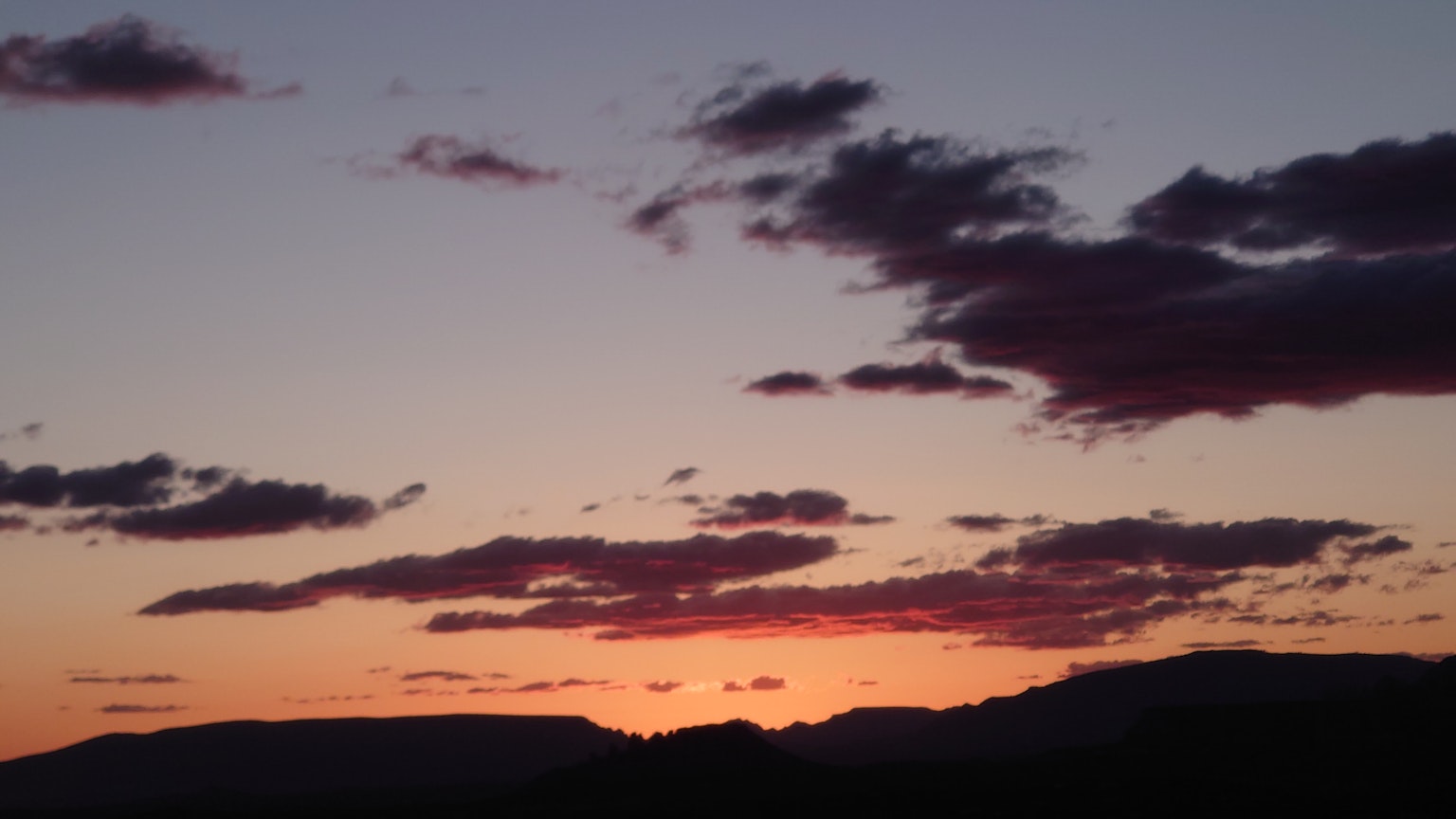 Sunset sky with silhouetted mountains