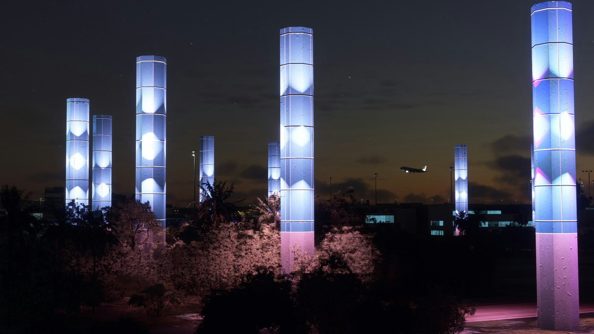 夜の公園で光る円柱ライトが並ぶ風景
