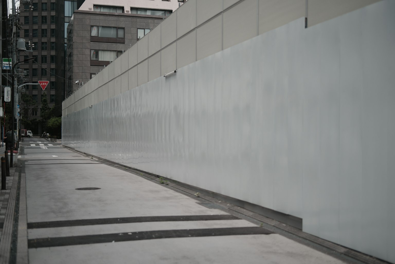Escena urbana con una pared de concreto y una carretera pavimentada