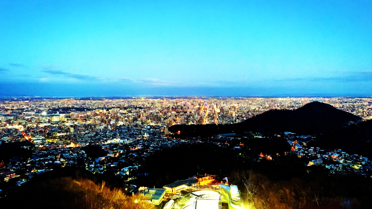 Stunning night view of a cityscape with mountains in the background