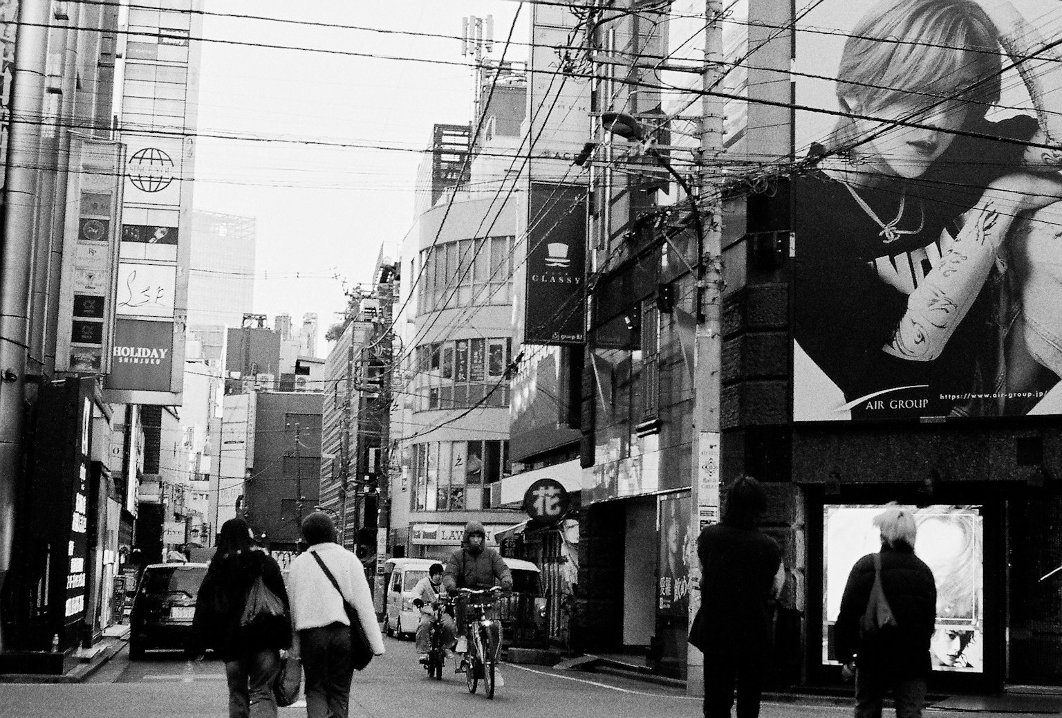 Escena de calle en blanco y negro con edificios y anuncios