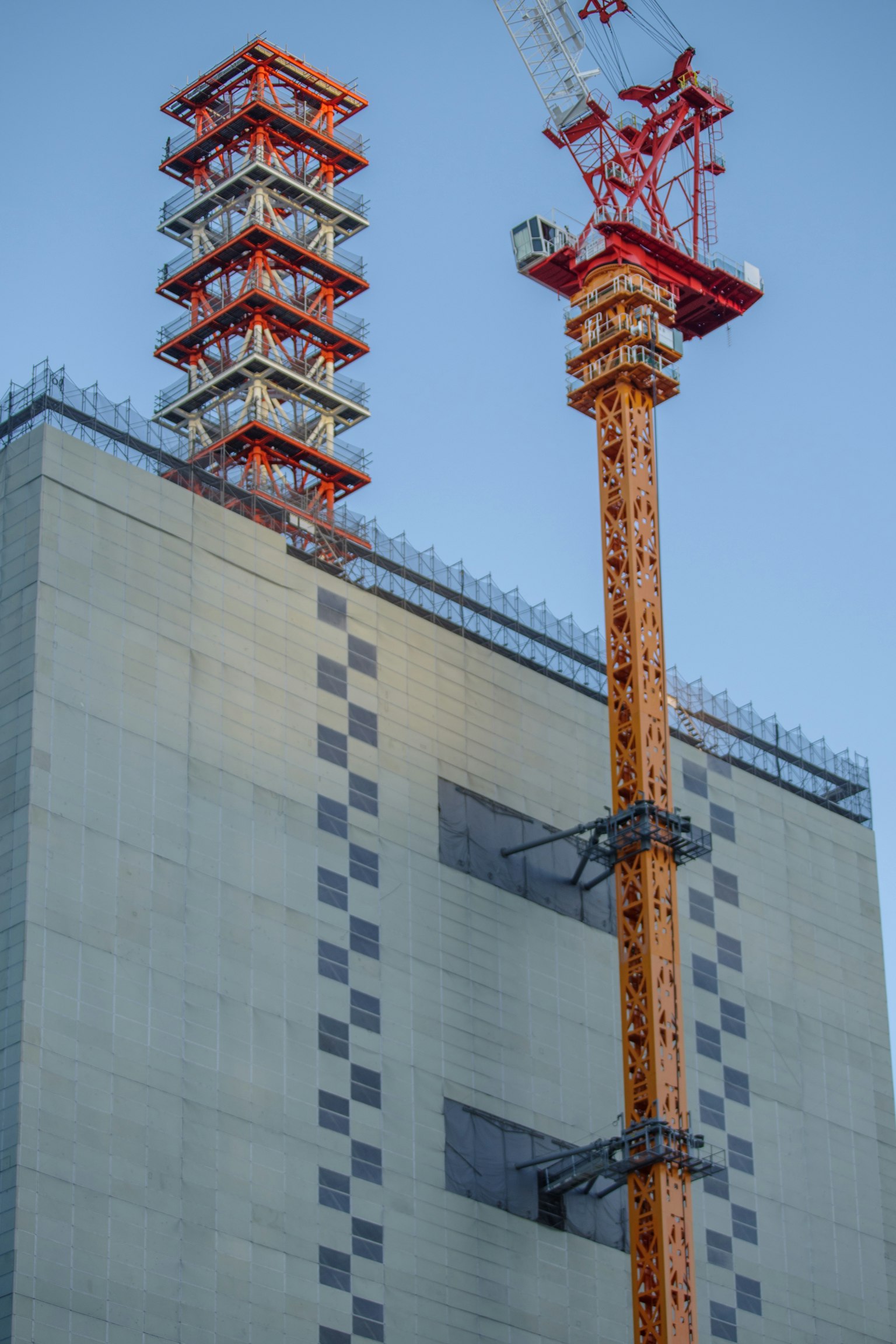 Detail of construction crane and equipment on a high-rise building