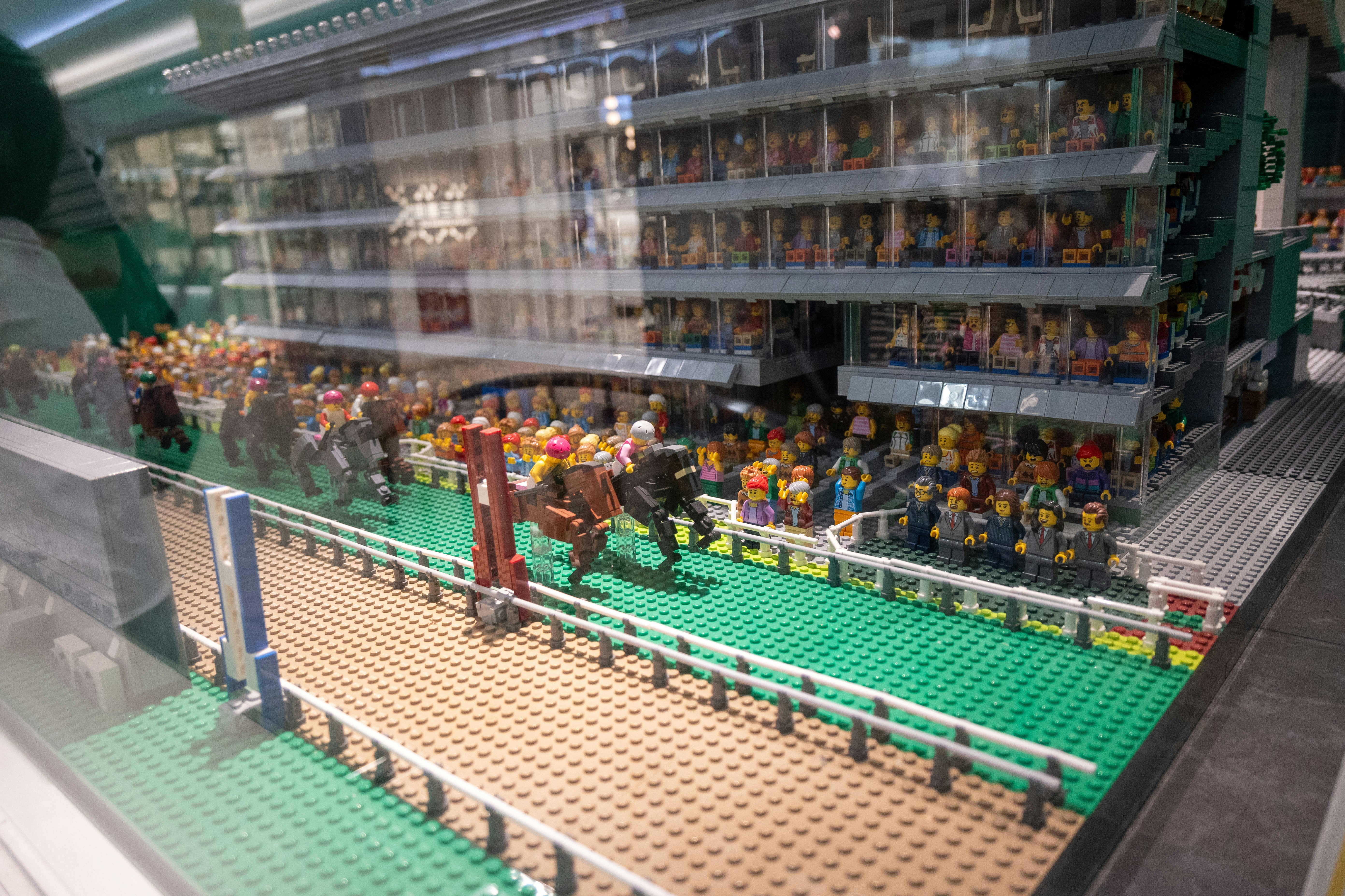 glass display case with rows of mini figurines