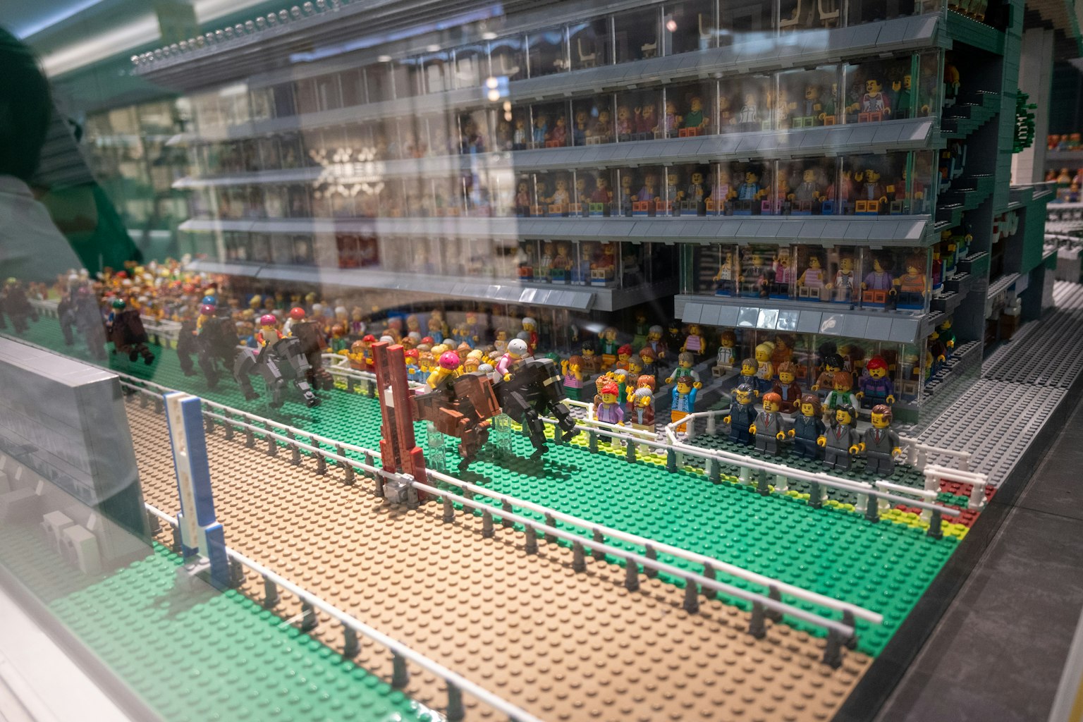 Lego model of a horse racing scene with spectators