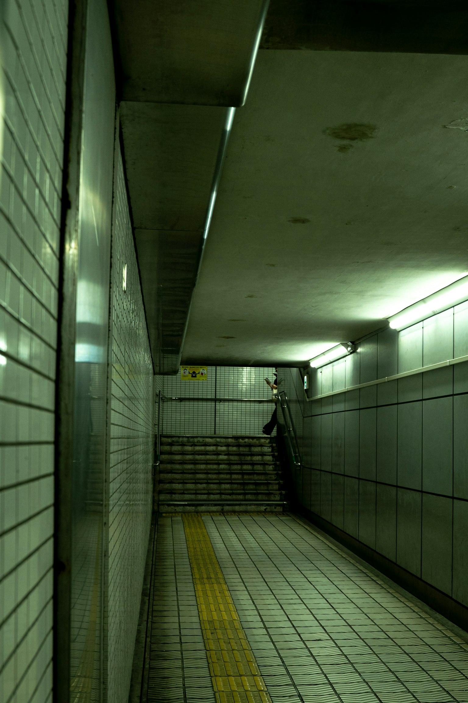 Long tunnel-like structure showing stairway and tiled walls