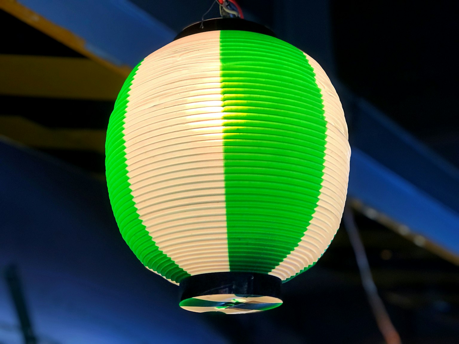 Green and white striped lantern hanging from above
