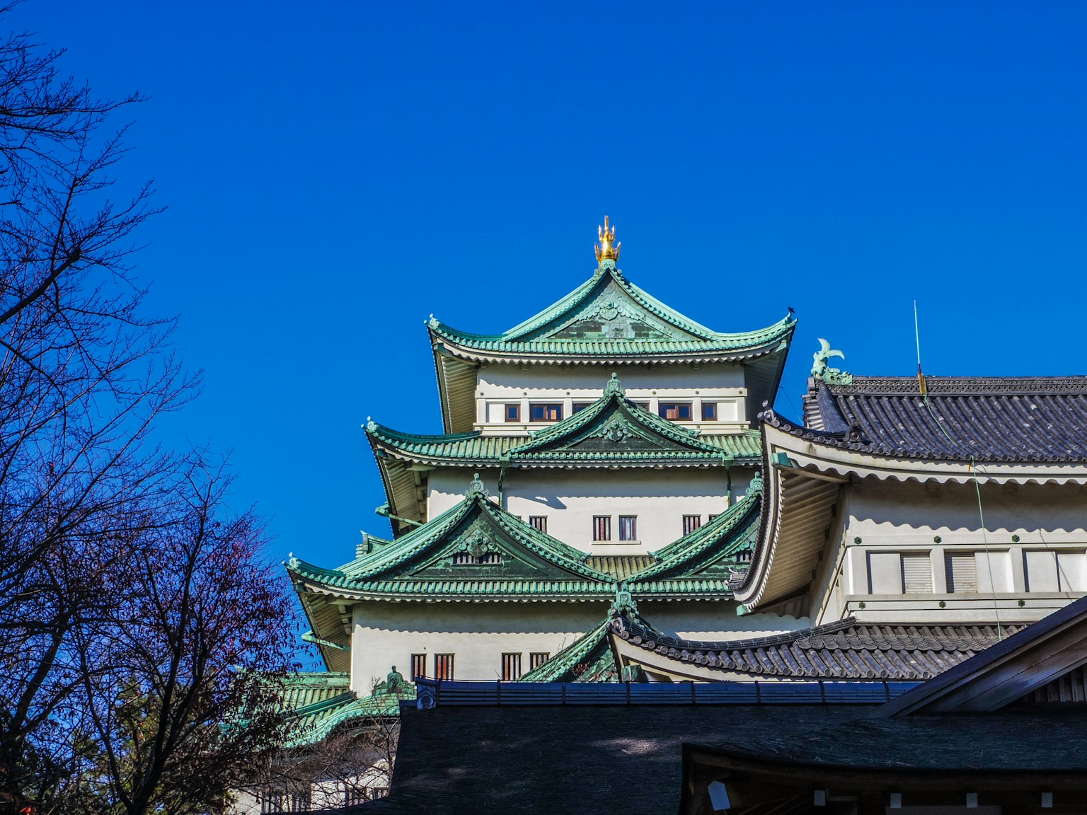 Nagoya Castle roof and decorations under a clear blue sky