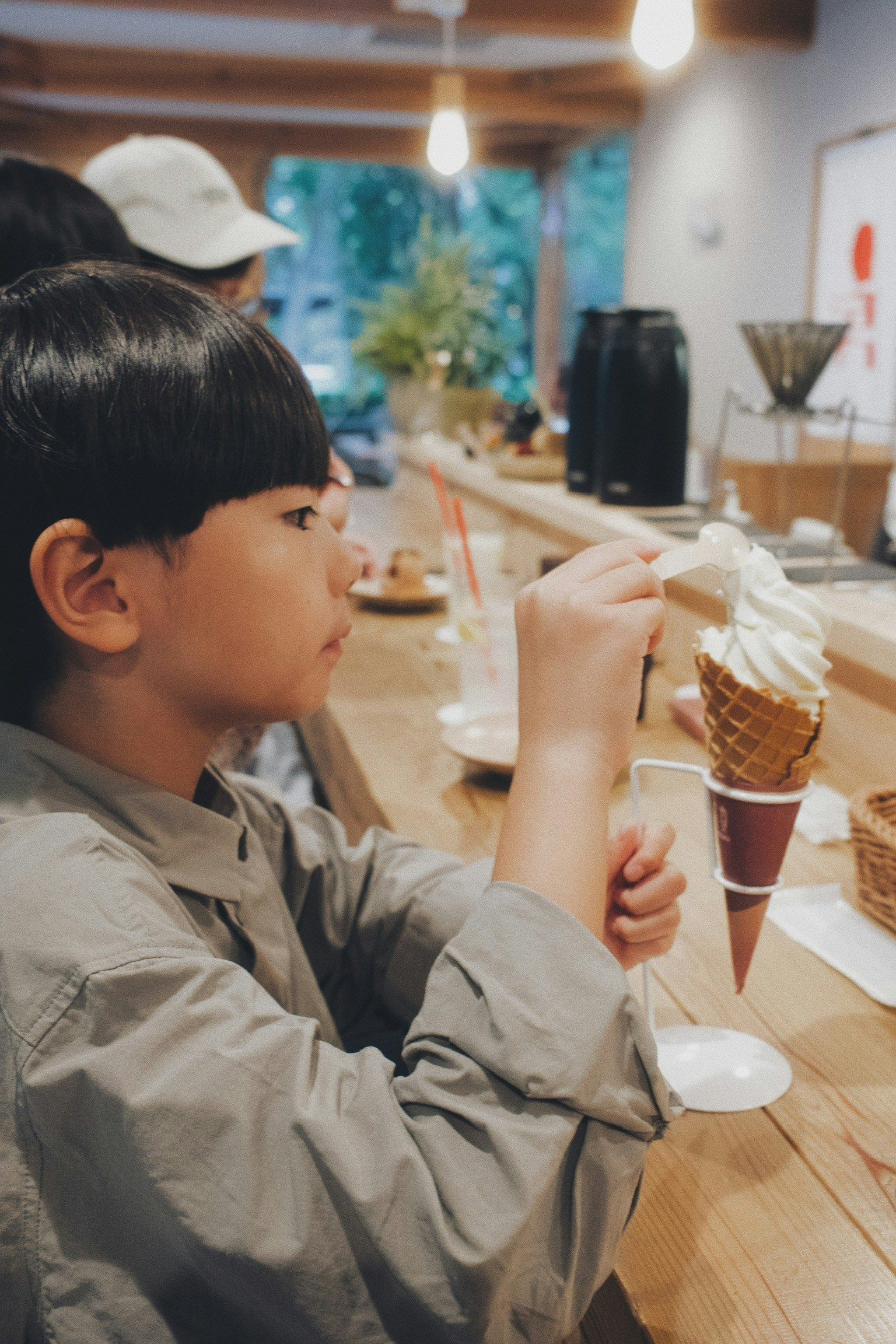 A child enjoying ice cream in a cozy café setting