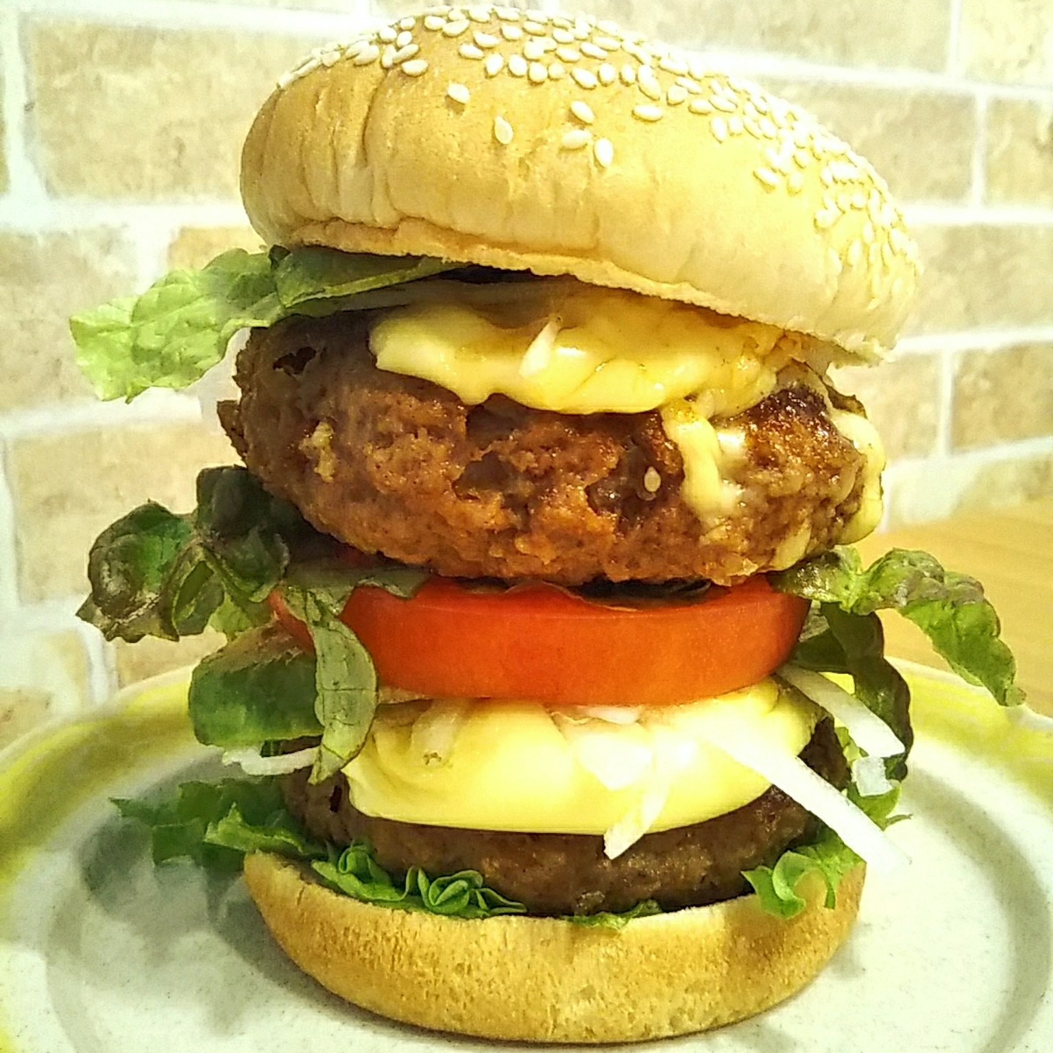 A delicious burger stacked with tomato lettuce and mayonnaise