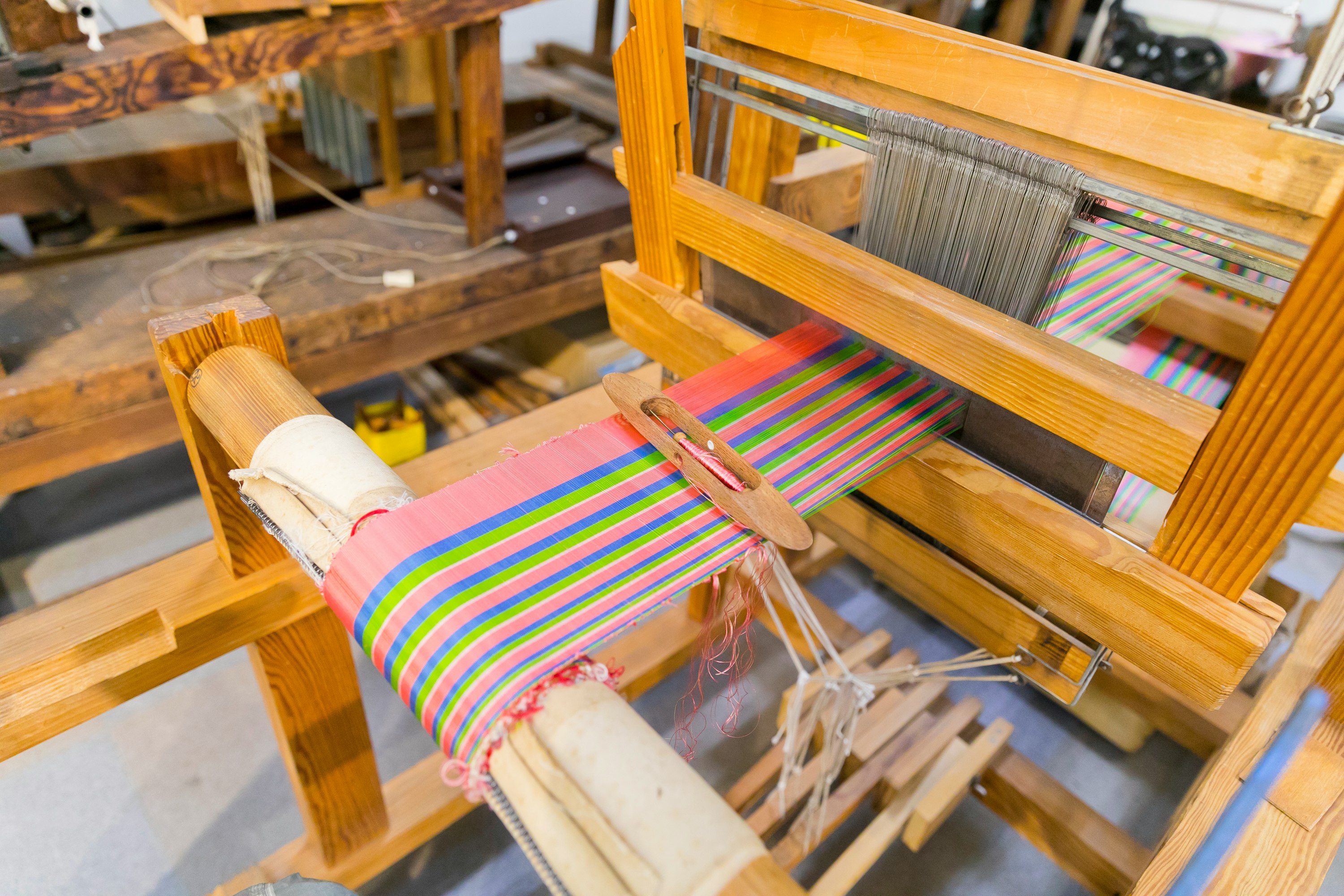 Colorful yarn weaving on a wooden loom