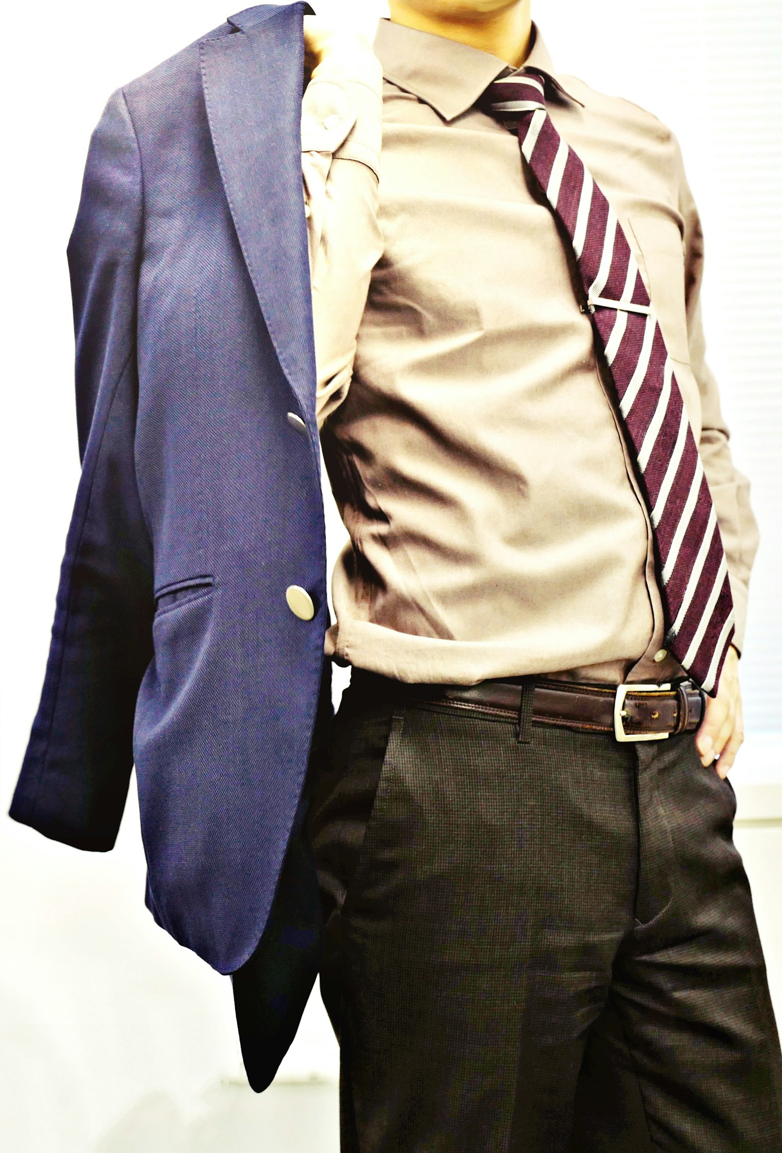 Man wearing a suit jacket on one side with a dress shirt and tie