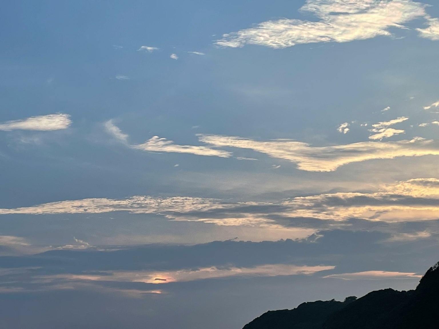 Evening sky with soft clouds and a hint of sunset