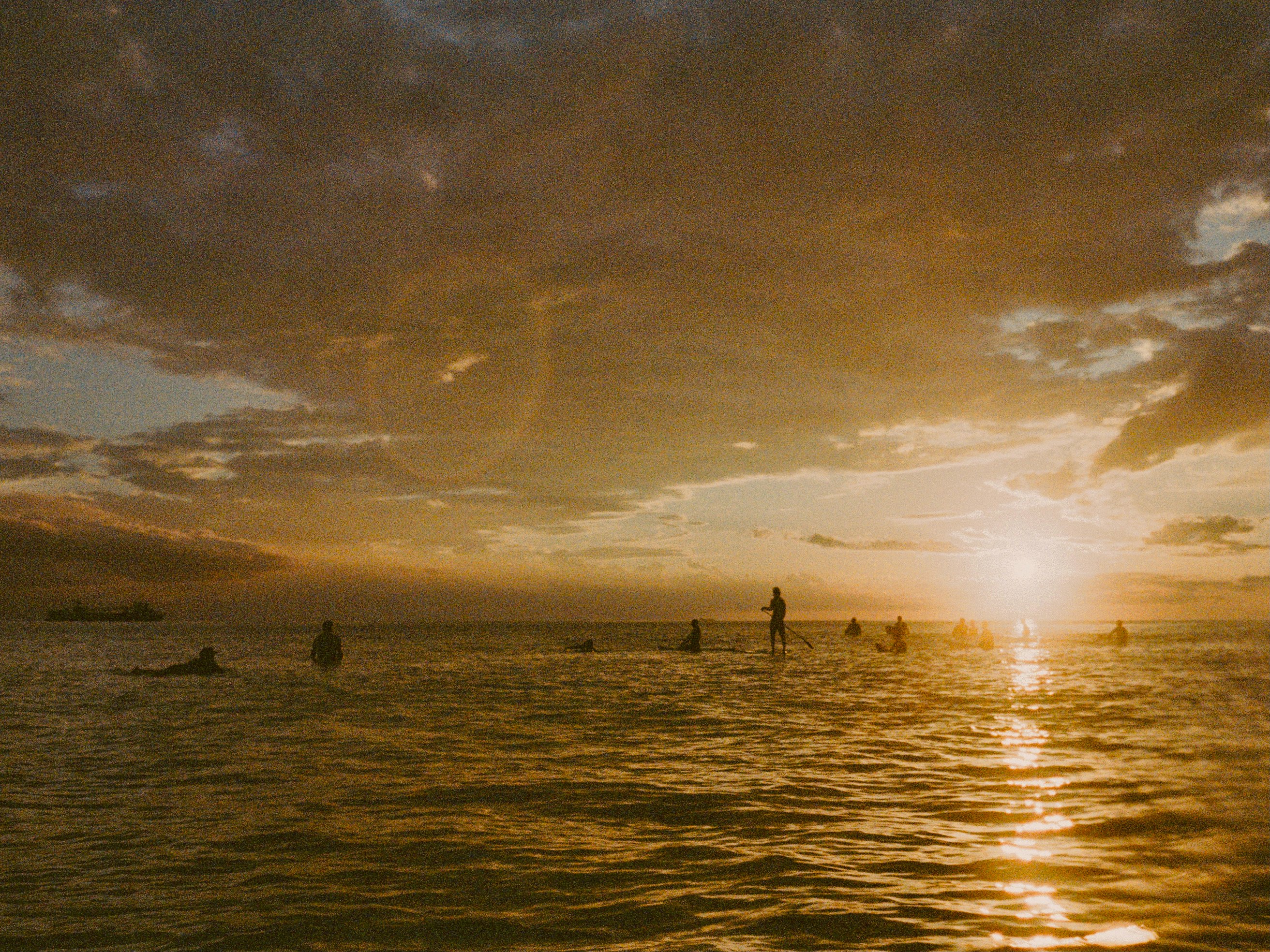 sunlit ocean waves and horizon at sunset