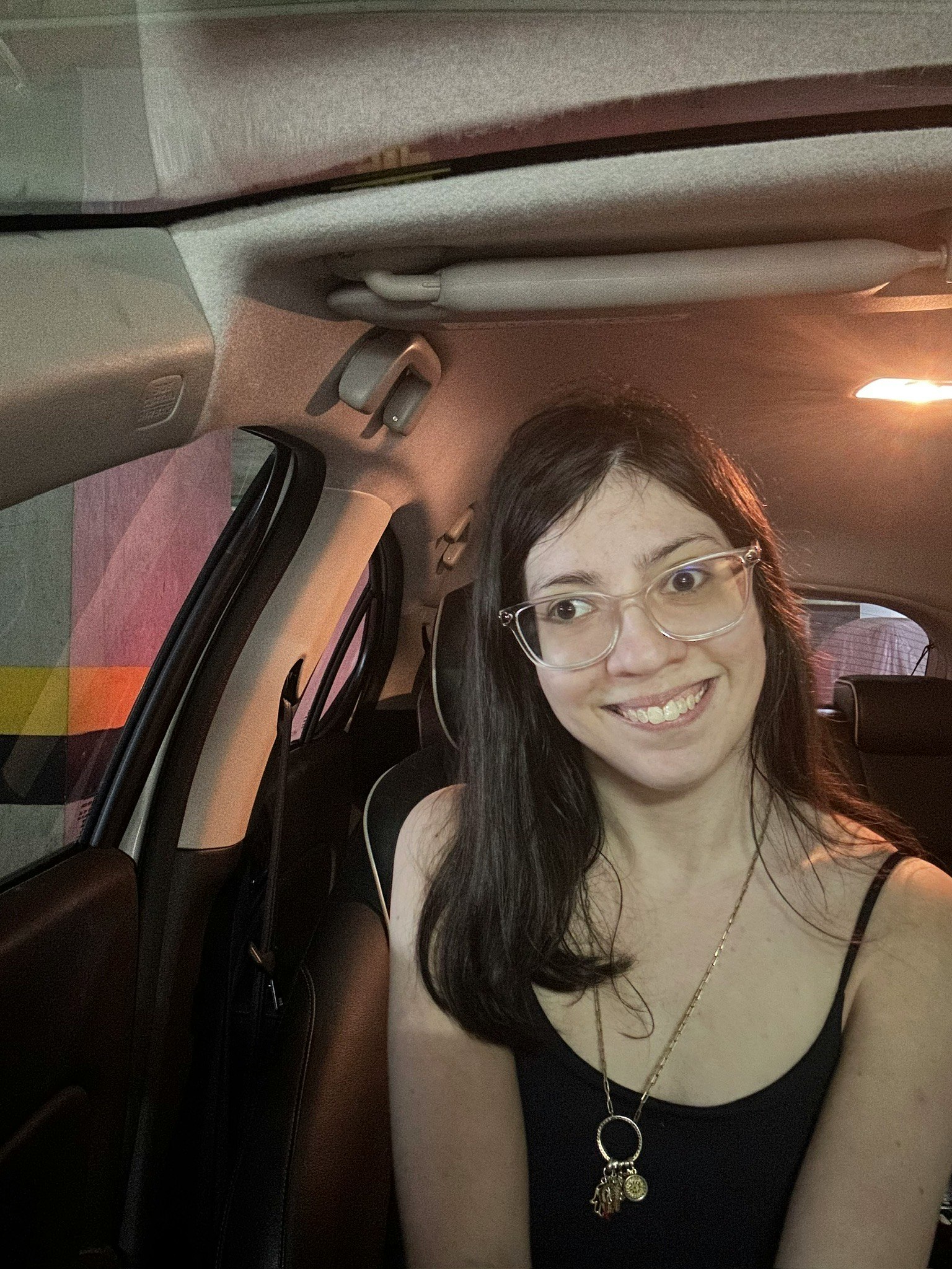 smiling woman inside a car