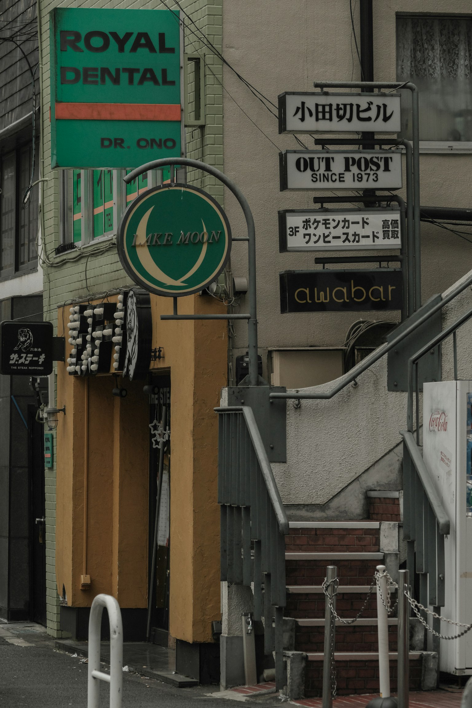 มุมถนนที่มีป้าย Royal Dental และบันได