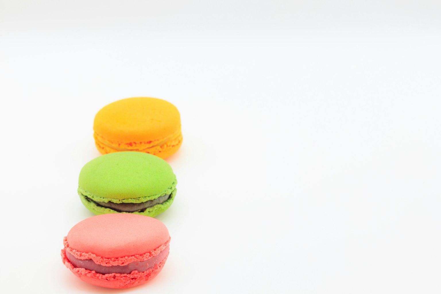 Colorful macarons arranged in a simple background