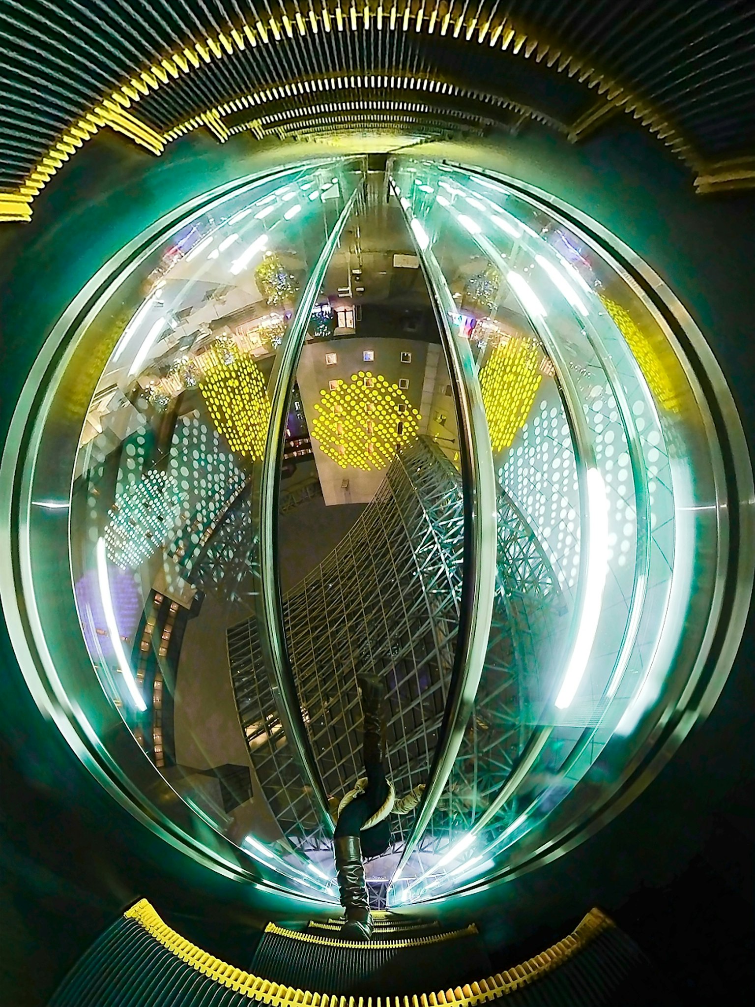 Image featuring a circular structure with unique reflections and vibrant lights