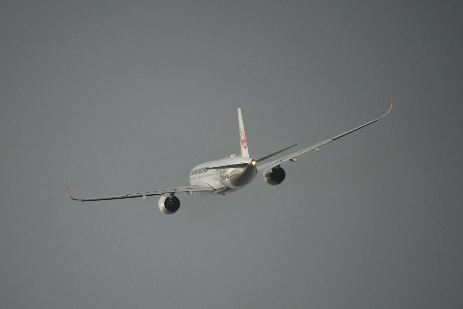 Airplane flying away in the sky