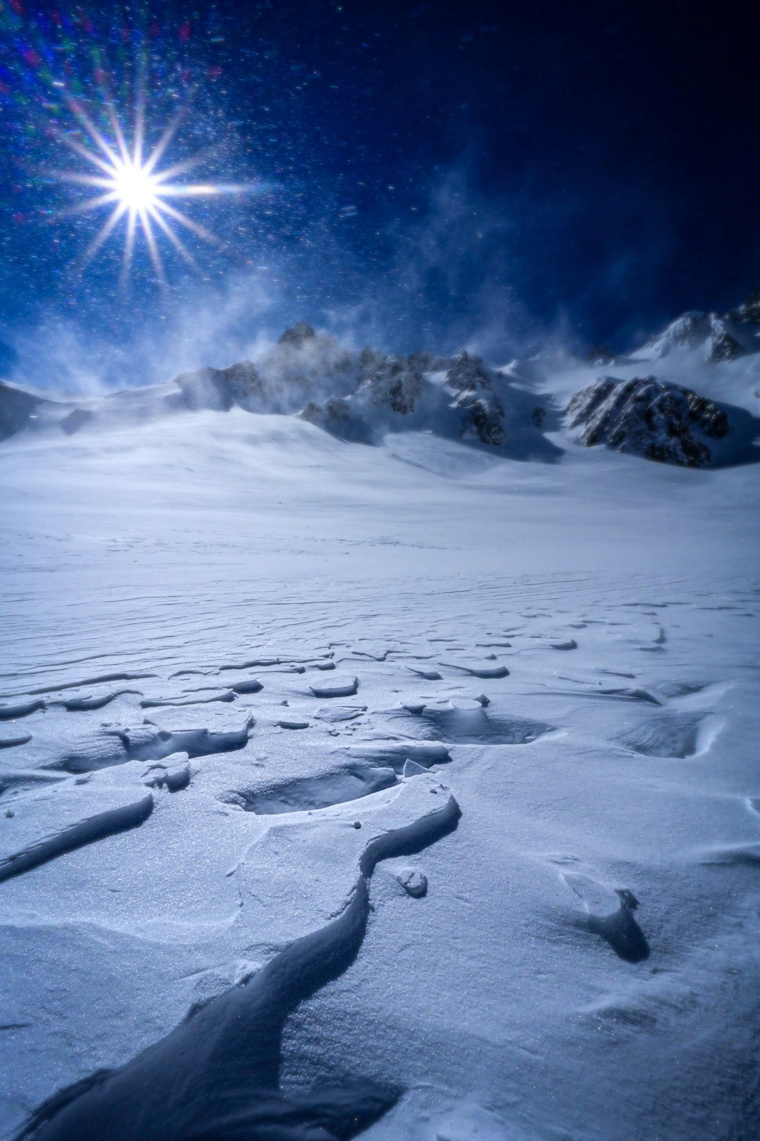 Snow-covered landscape with radiant sunlight