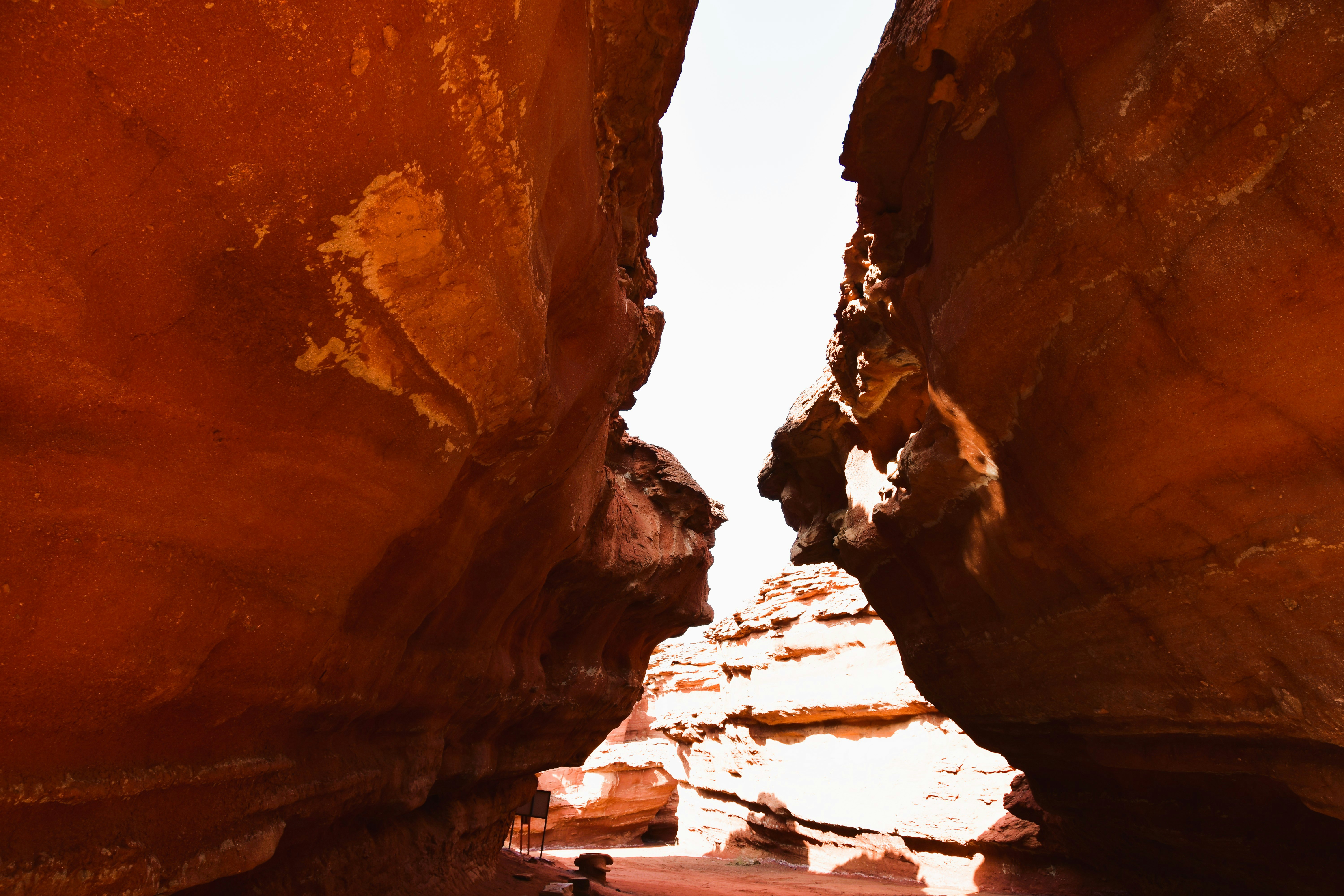 canyon rock walls with light streaming through the gap