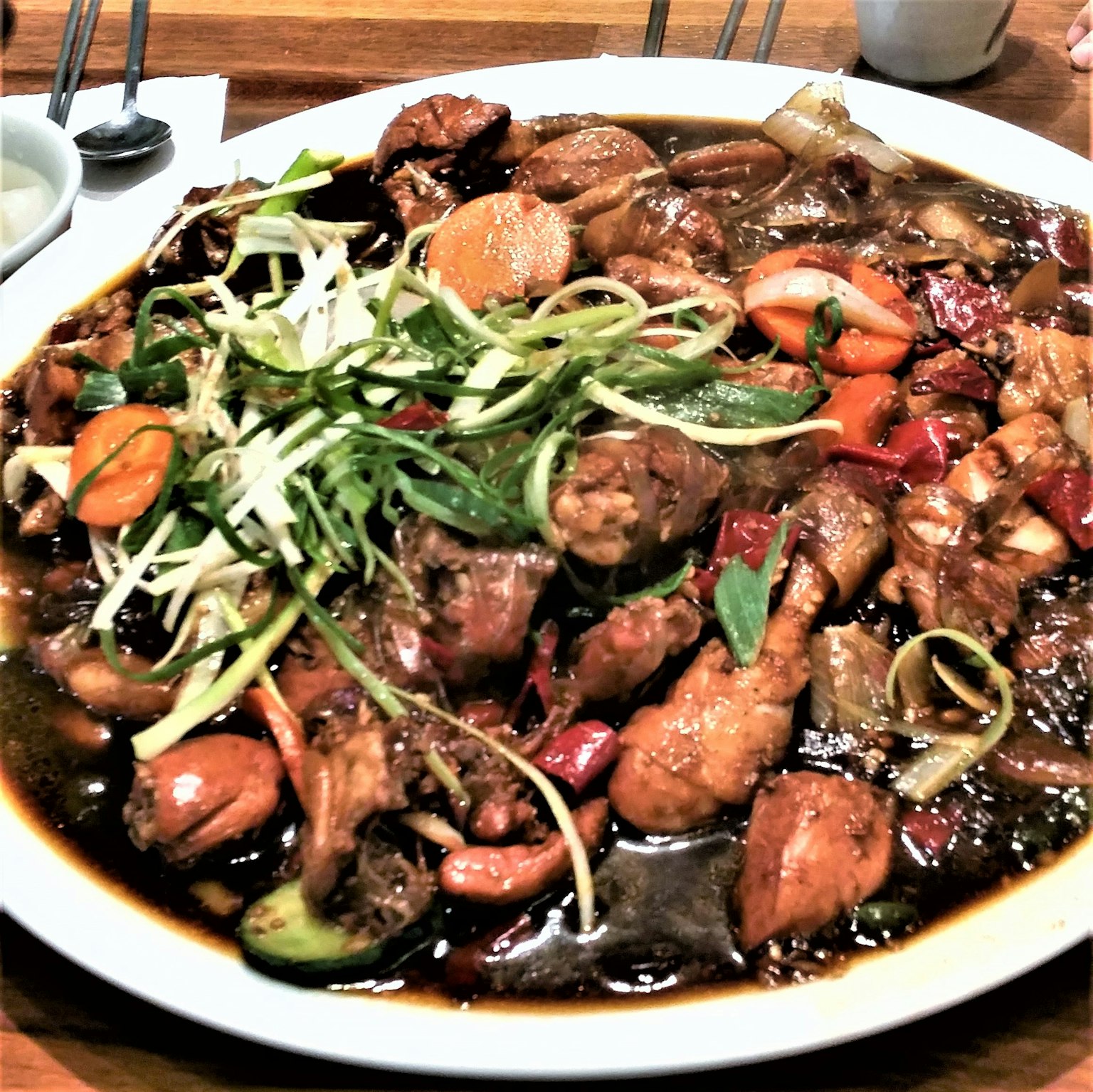 A colorful dish of chicken and vegetables presented on a plate