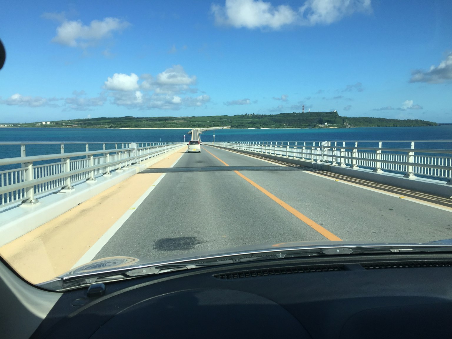 Vista di un ponte che si estende su un mare blu sotto un cielo sereno